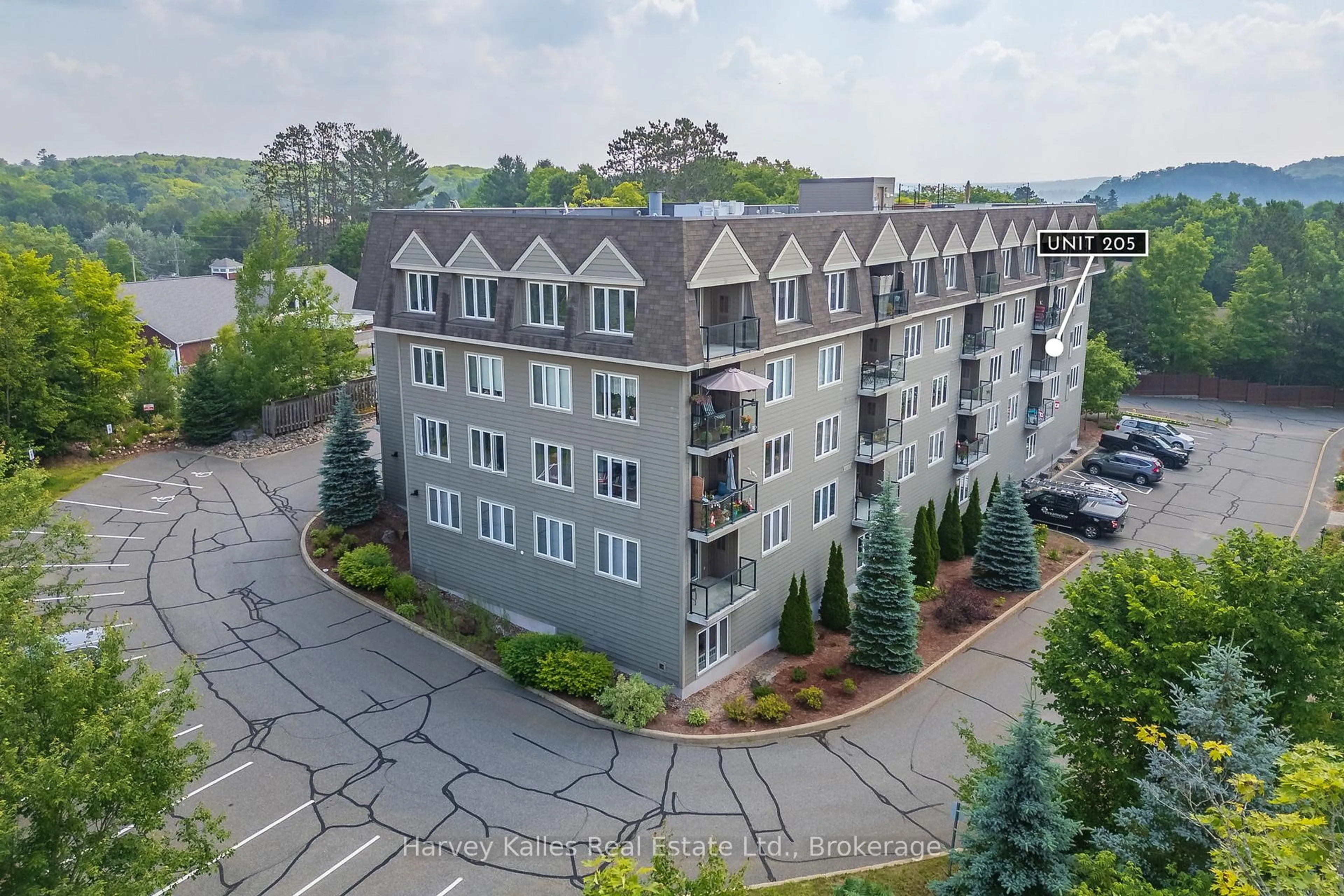 A pic from outside/outdoor area/front of a property/back of a property/a pic from drone, mountain view for 26 Dairy Lane #205, Huntsville Ontario P1H 0A4