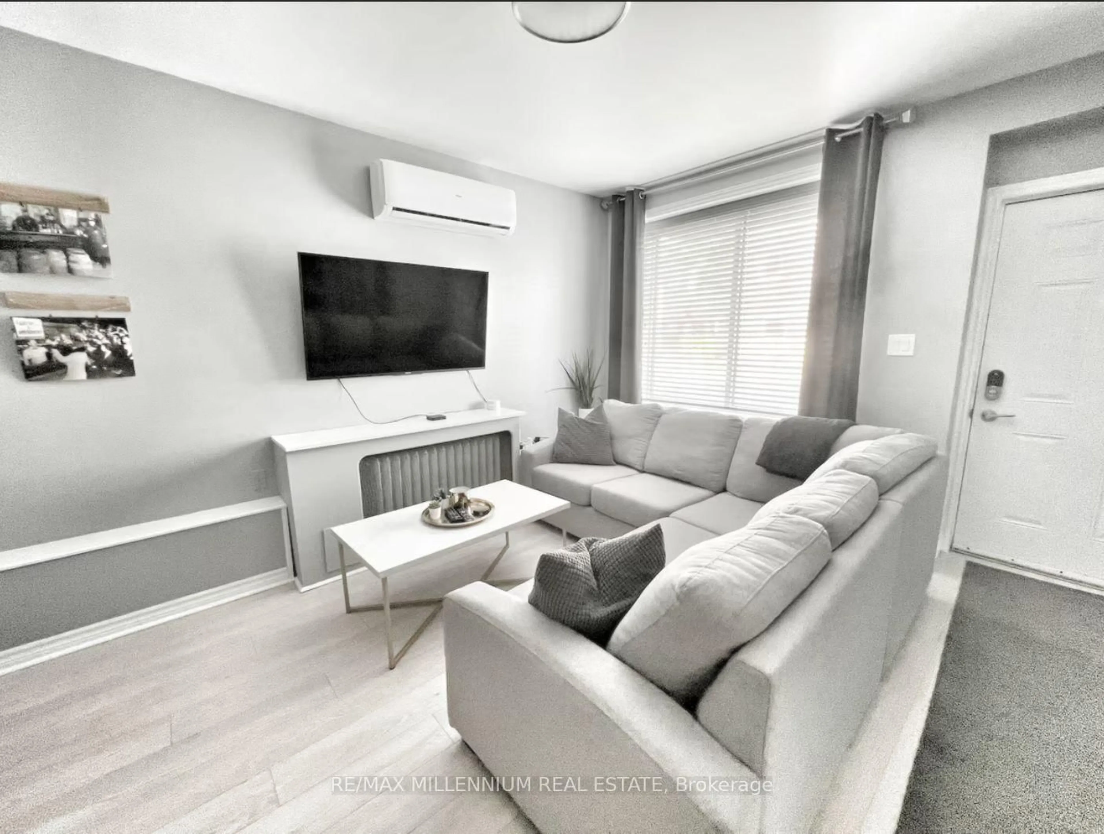 Living room with furniture, wood/laminate floor for 1064 Monmouth Rd, Windsor Ontario N8Y 3L7
