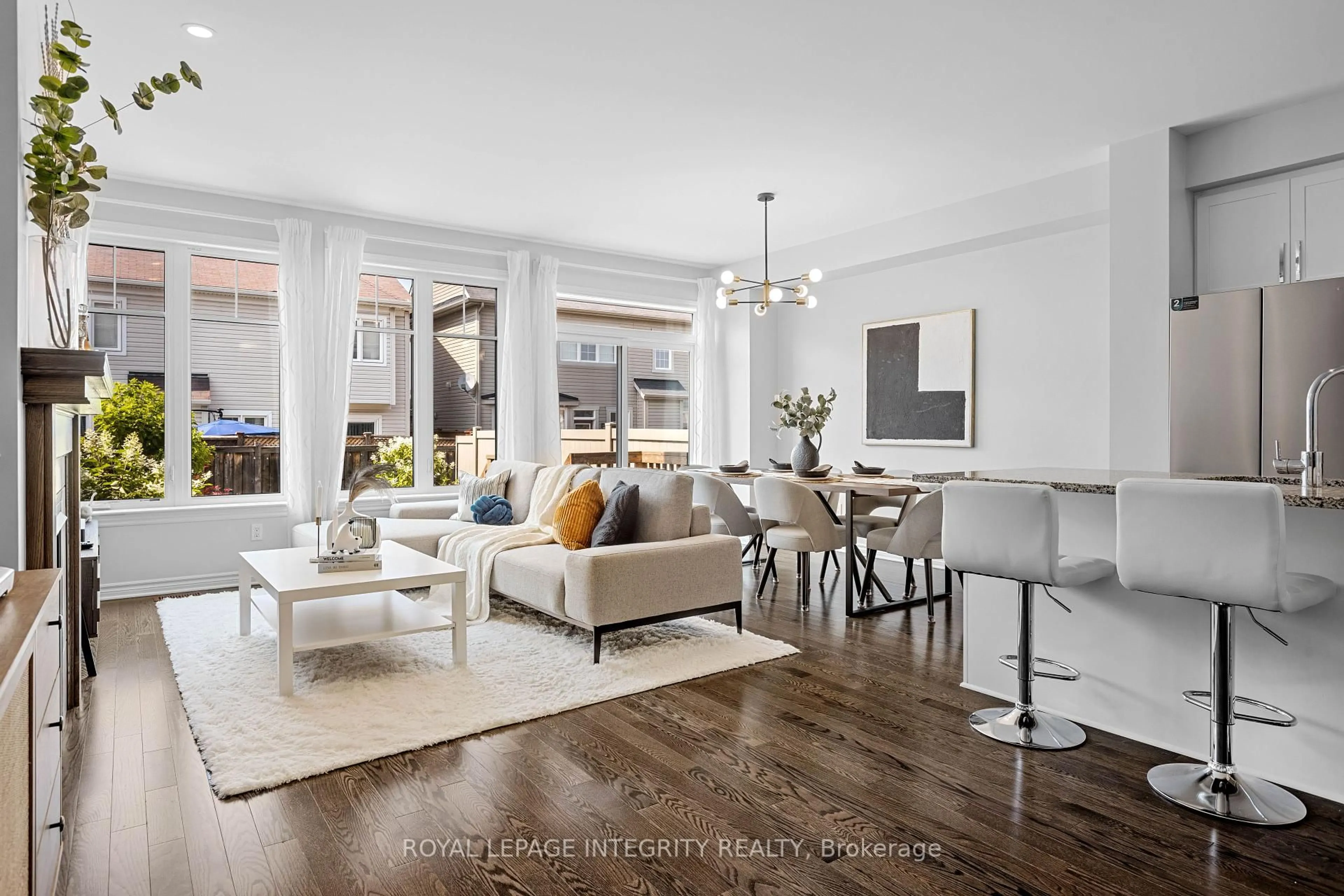 Living room with furniture, wood/laminate floor for 219 BRAMBLING Way, Ottawa Ontario K2J 0E4