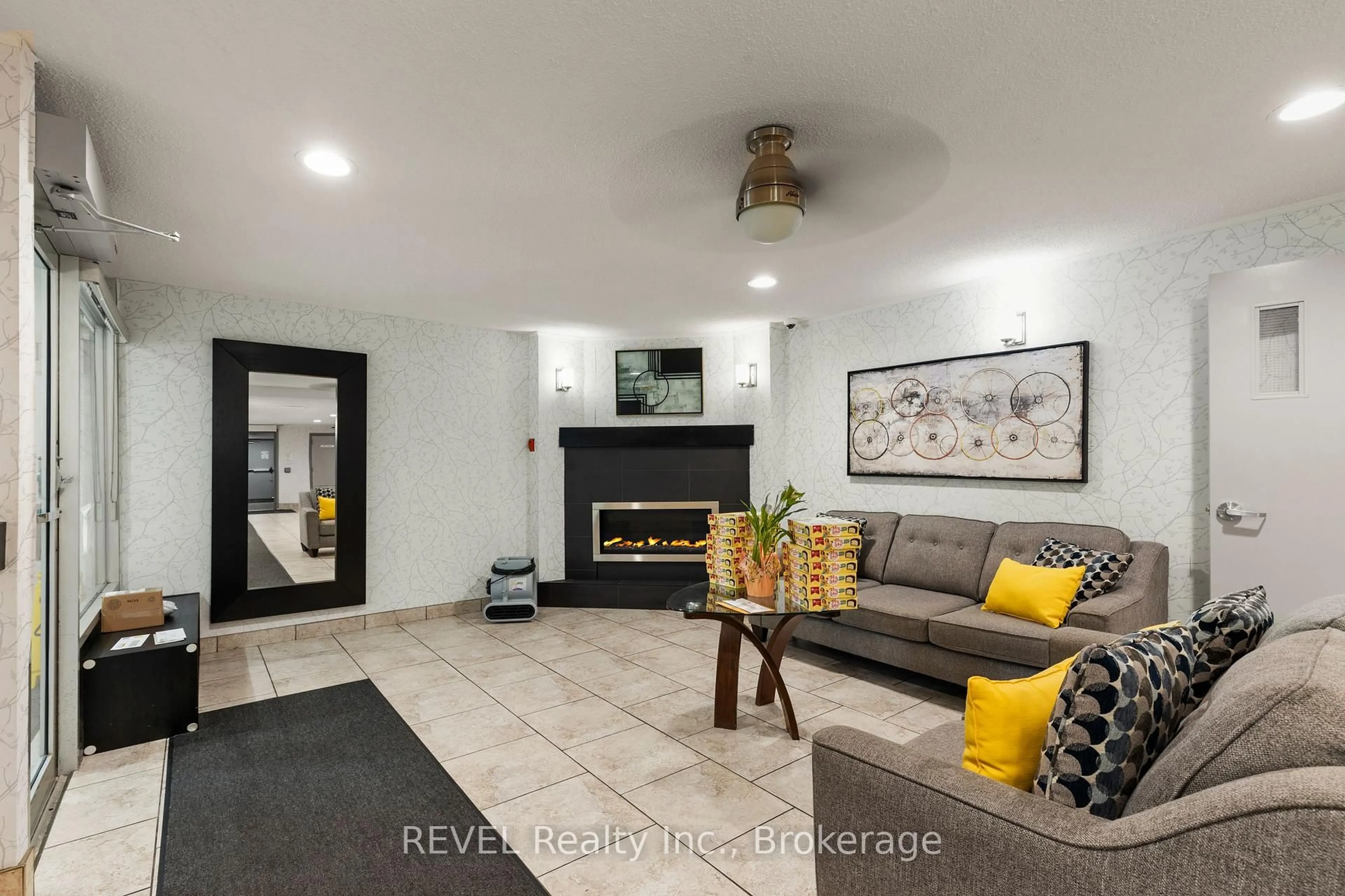 Living room with furniture, ceramic/tile floor for 198 SCOTT St #317, St. Catharines Ontario L2N 5T3