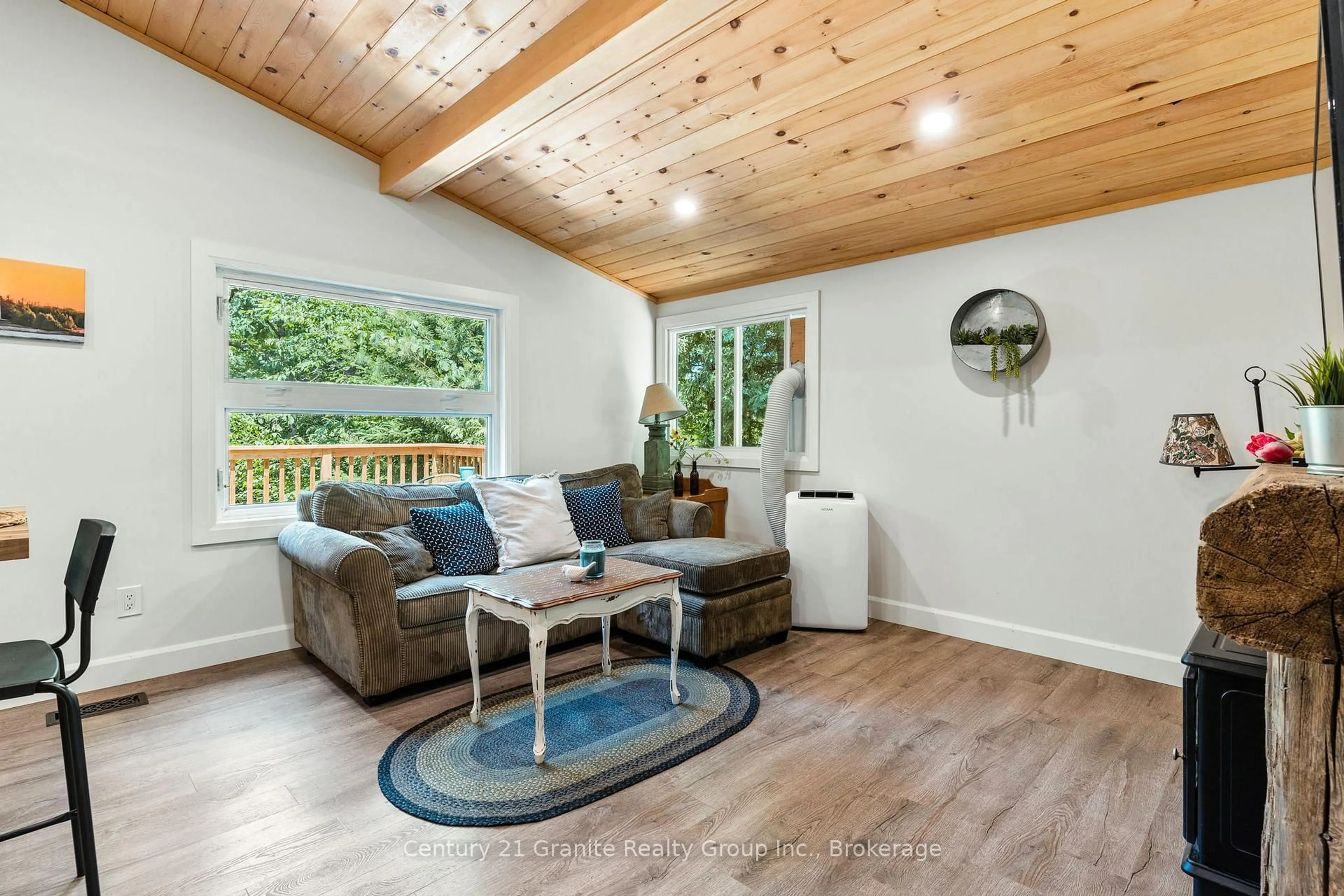 Living room with furniture, wood/laminate floor for 10979 Highway 118, Algonquin Highlands Ontario K0M 1S0