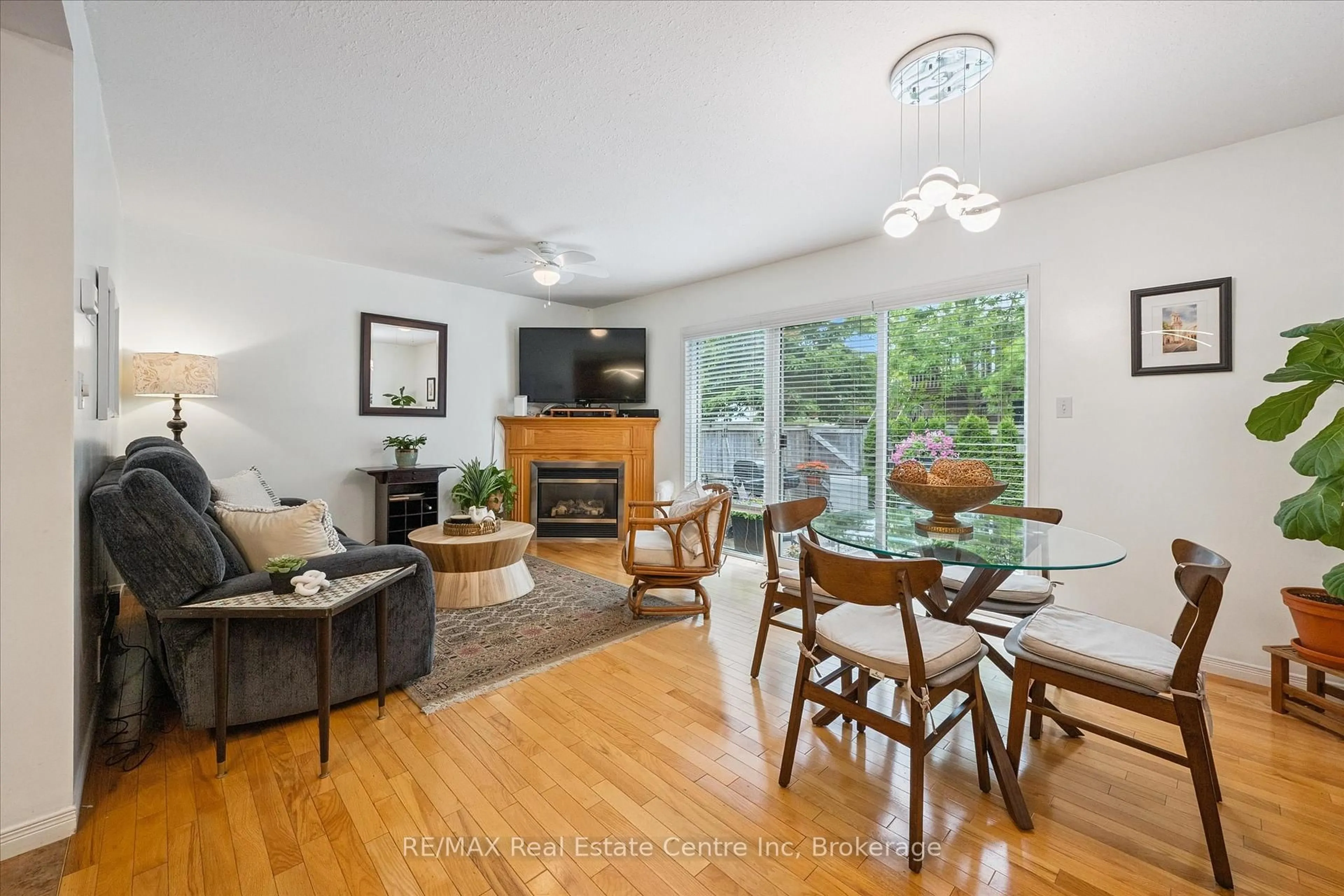Living room with furniture, wood/laminate floor for 31 Schroder Cres #24, Guelph Ontario N1E 7M6