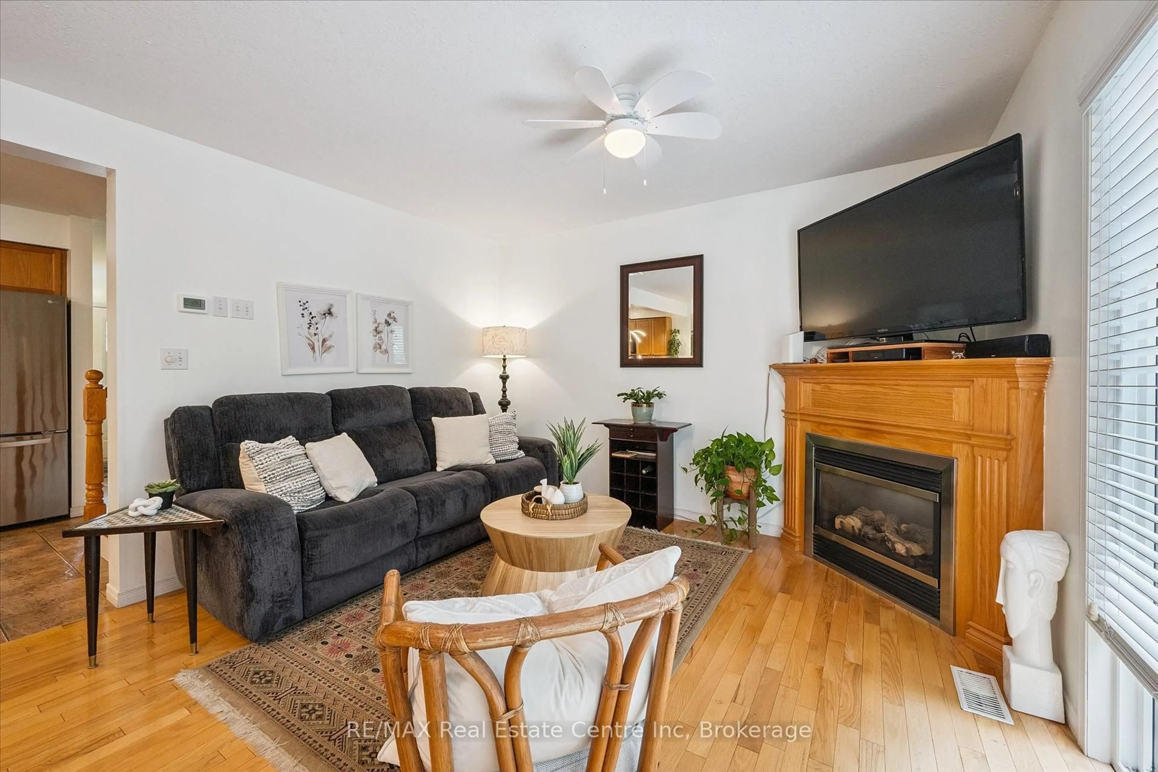 Living room with furniture, wood/laminate floor for 31 Schroder Cres #24, Guelph Ontario N1E 7M6