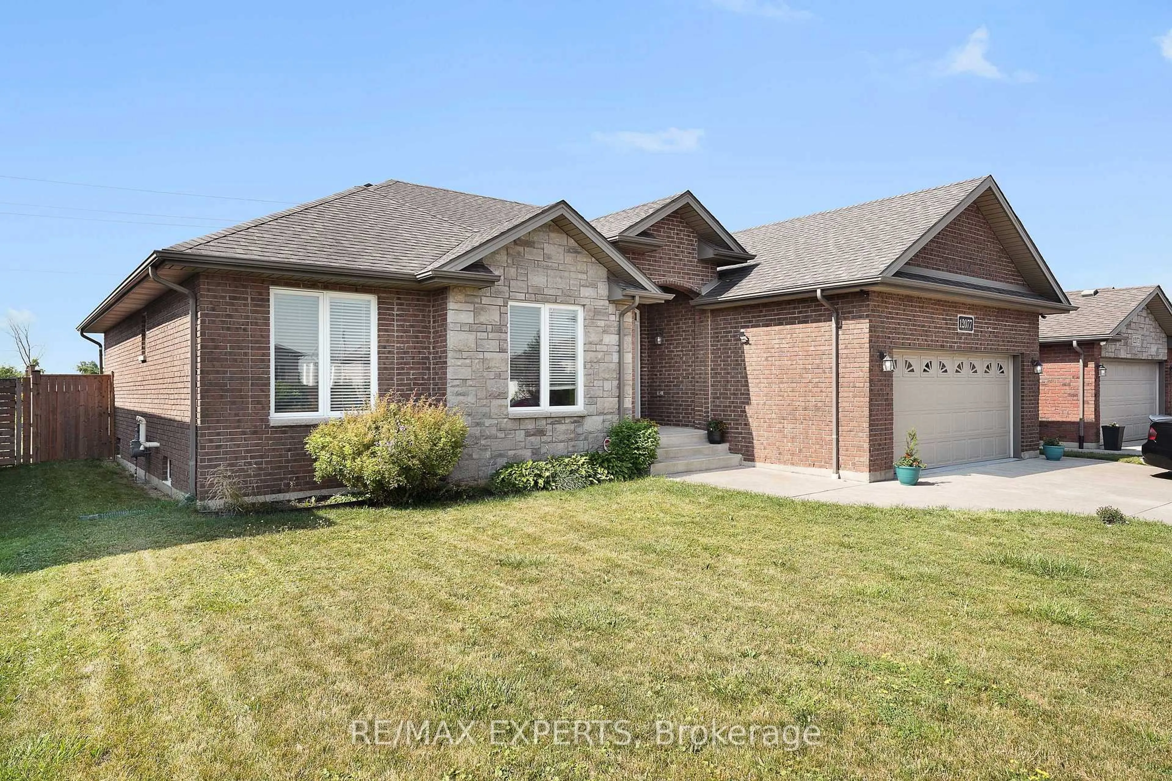 Home with brick exterior material, street for 12077 Ducharme Lane, Essex Ontario N0R 1J0
