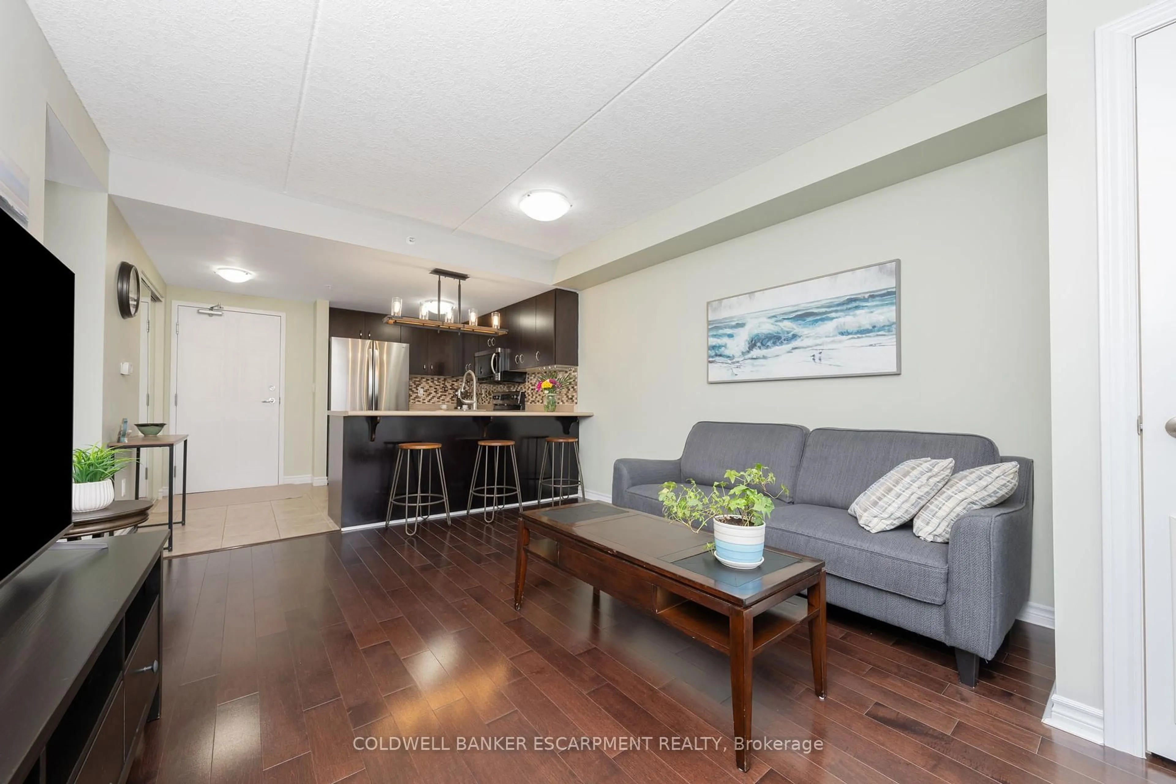 Living room with furniture, wood/laminate floor for 43 Goodwin Dr #109, Guelph Ontario N1L 0E8