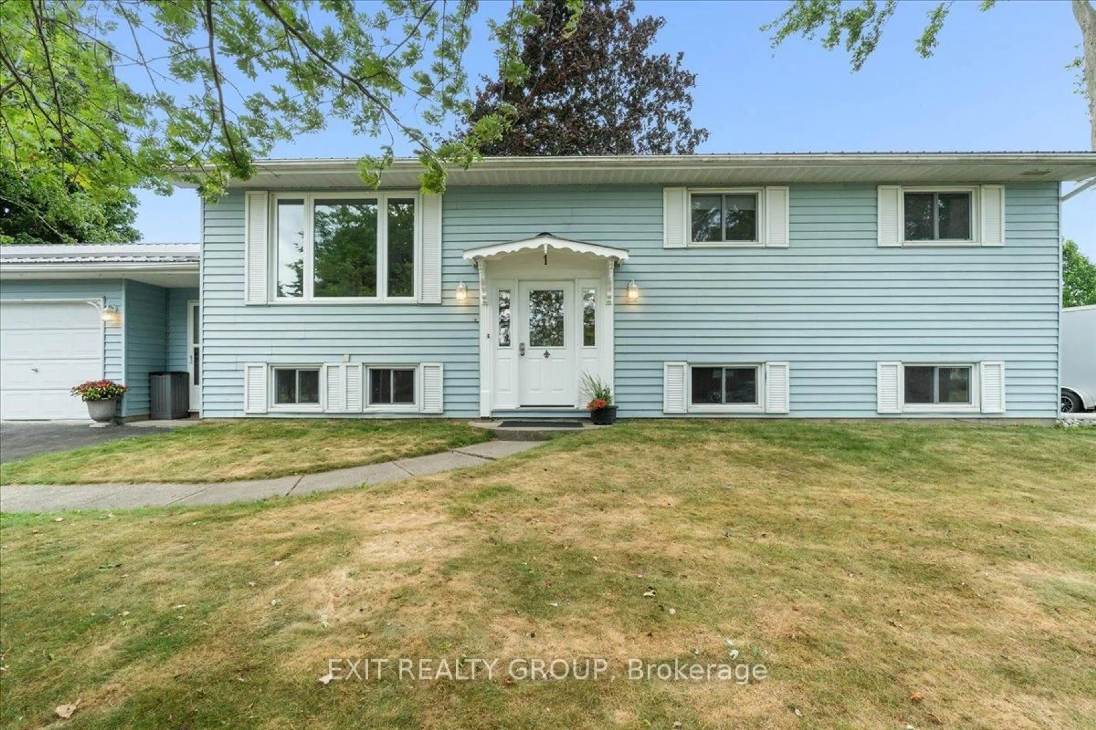 Home with vinyl exterior material, street for 1 Queen St, Brighton Ontario K0K 1H0