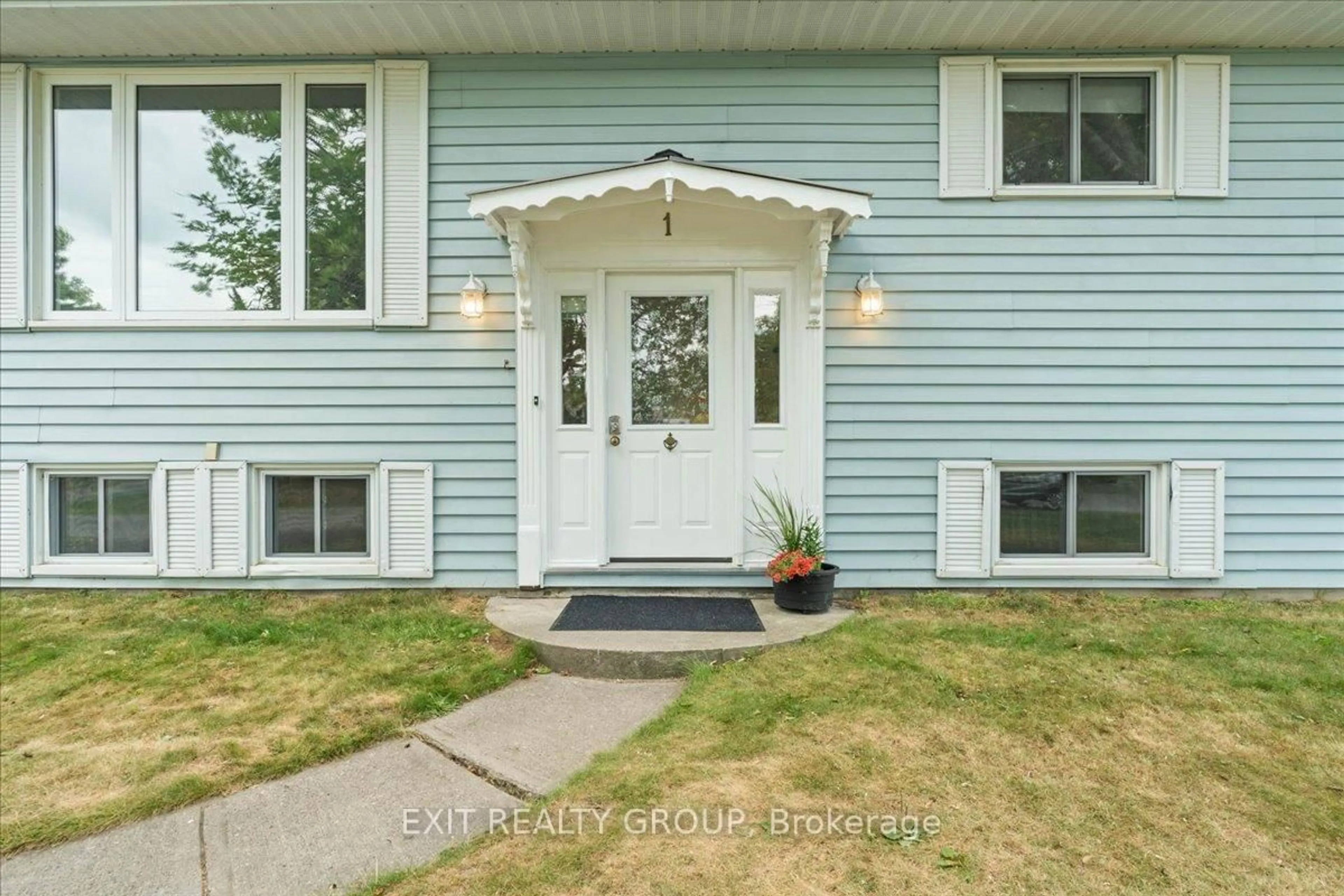 Home with vinyl exterior material, street for 1 Queen St, Brighton Ontario K0K 1H0