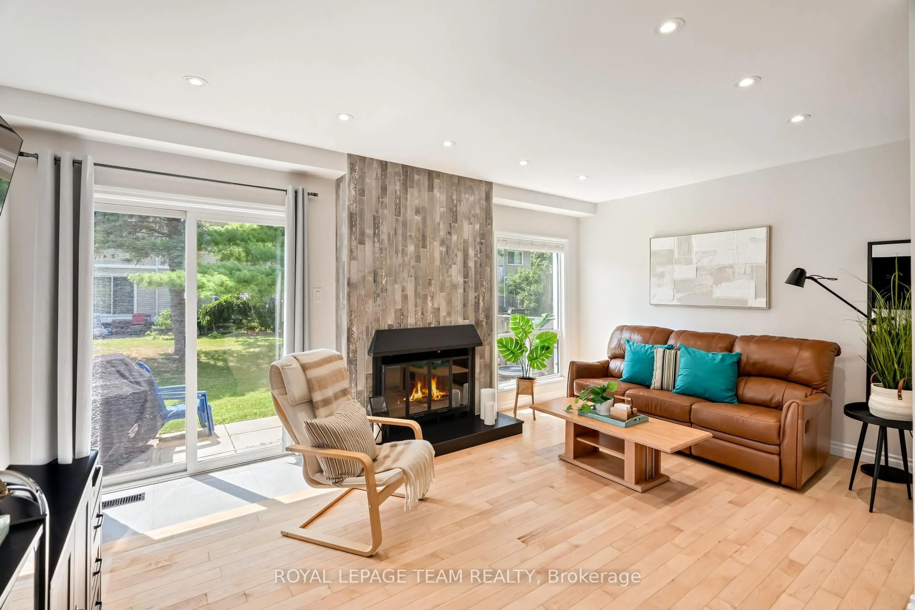 Living room with furniture, wood/laminate floor for 177 Valley Stream Dr #A, Ottawa Ontario K2H 9C7
