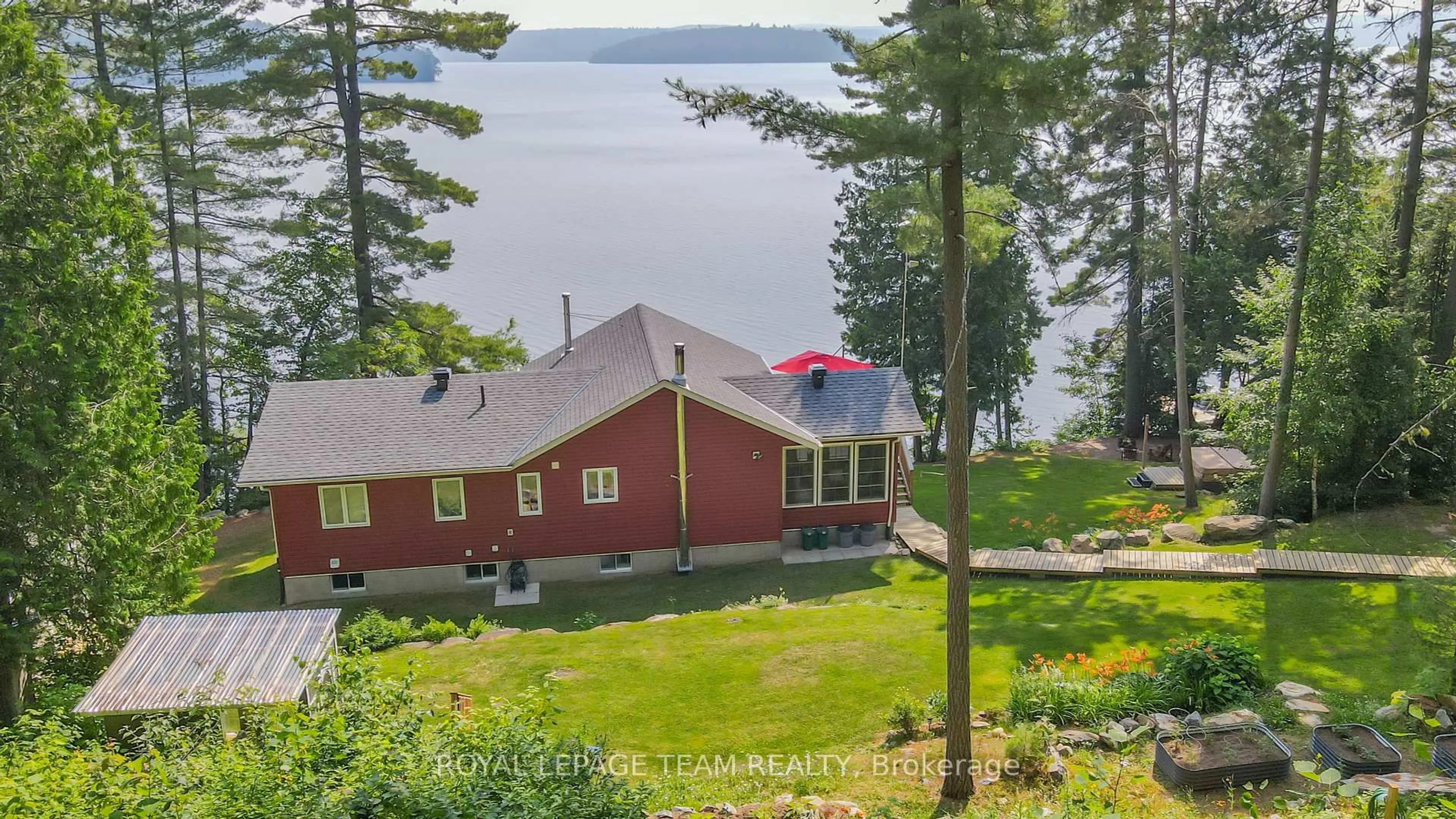 A pic from outside/outdoor area/front of a property/back of a property/a pic from drone, water/lake/river/ocean view for 34 Moose Track Lane, South Algonquin Ontario K0J 2C0