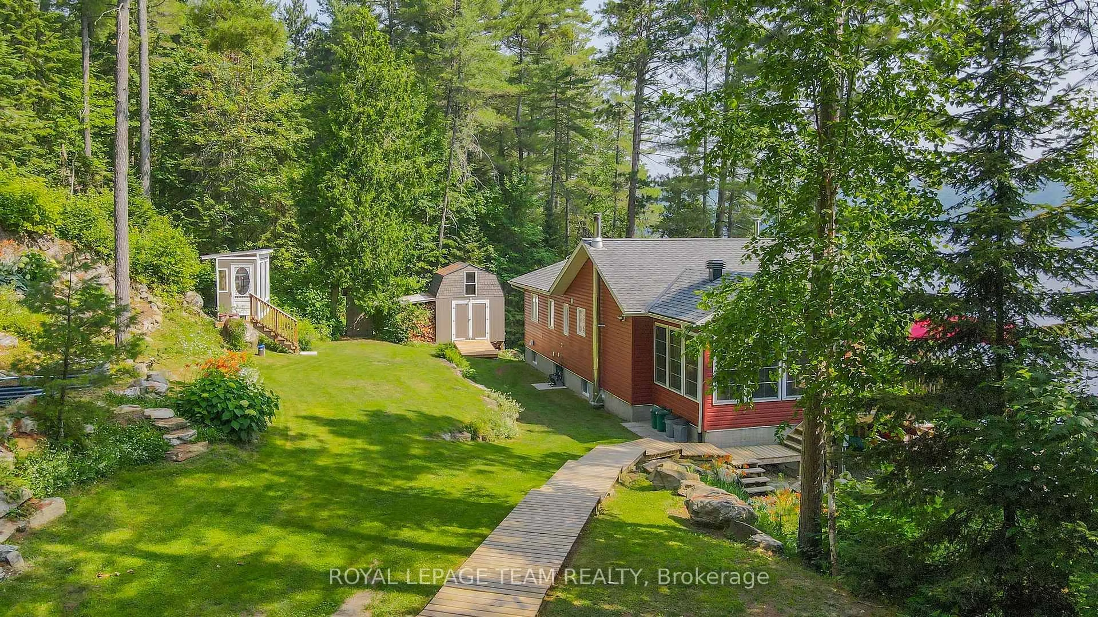 A pic from outside/outdoor area/front of a property/back of a property/a pic from drone, forest/trees view for 34 Moose Track Lane, South Algonquin Ontario K0J 2C0