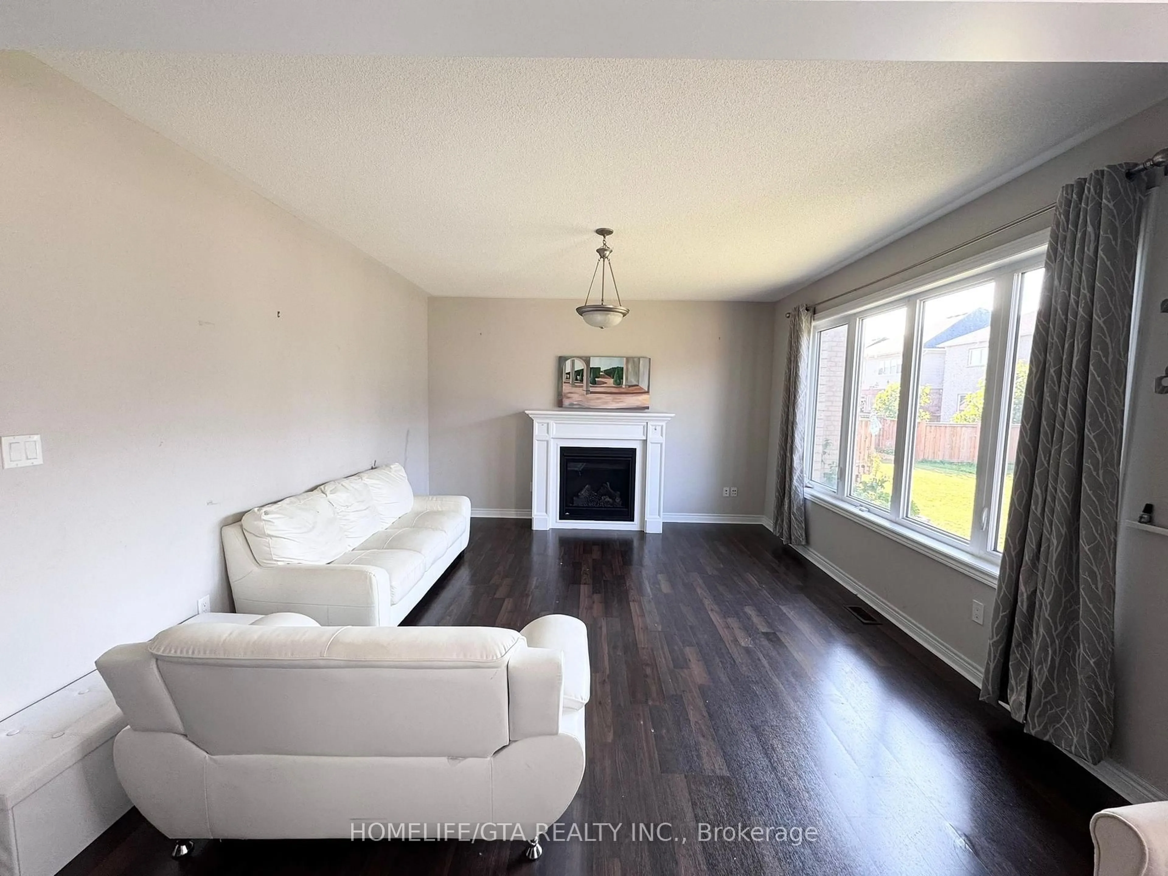 Living room with furniture, wood/laminate floor for 61 Barlow Pl, Brant Ontario N3L 0H1