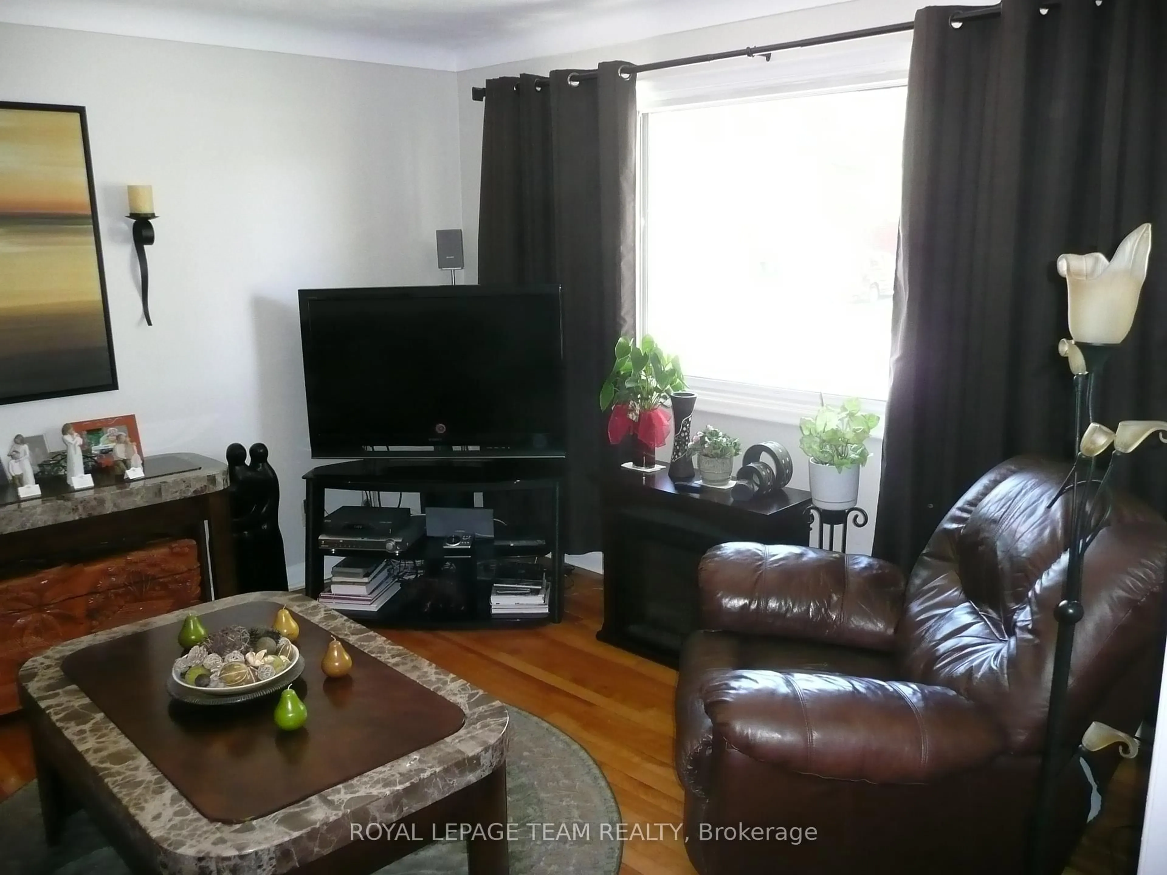 Living room with furniture, wood/laminate floor for 775 Trojan Ave, Ottawa Ontario K1K 2P6