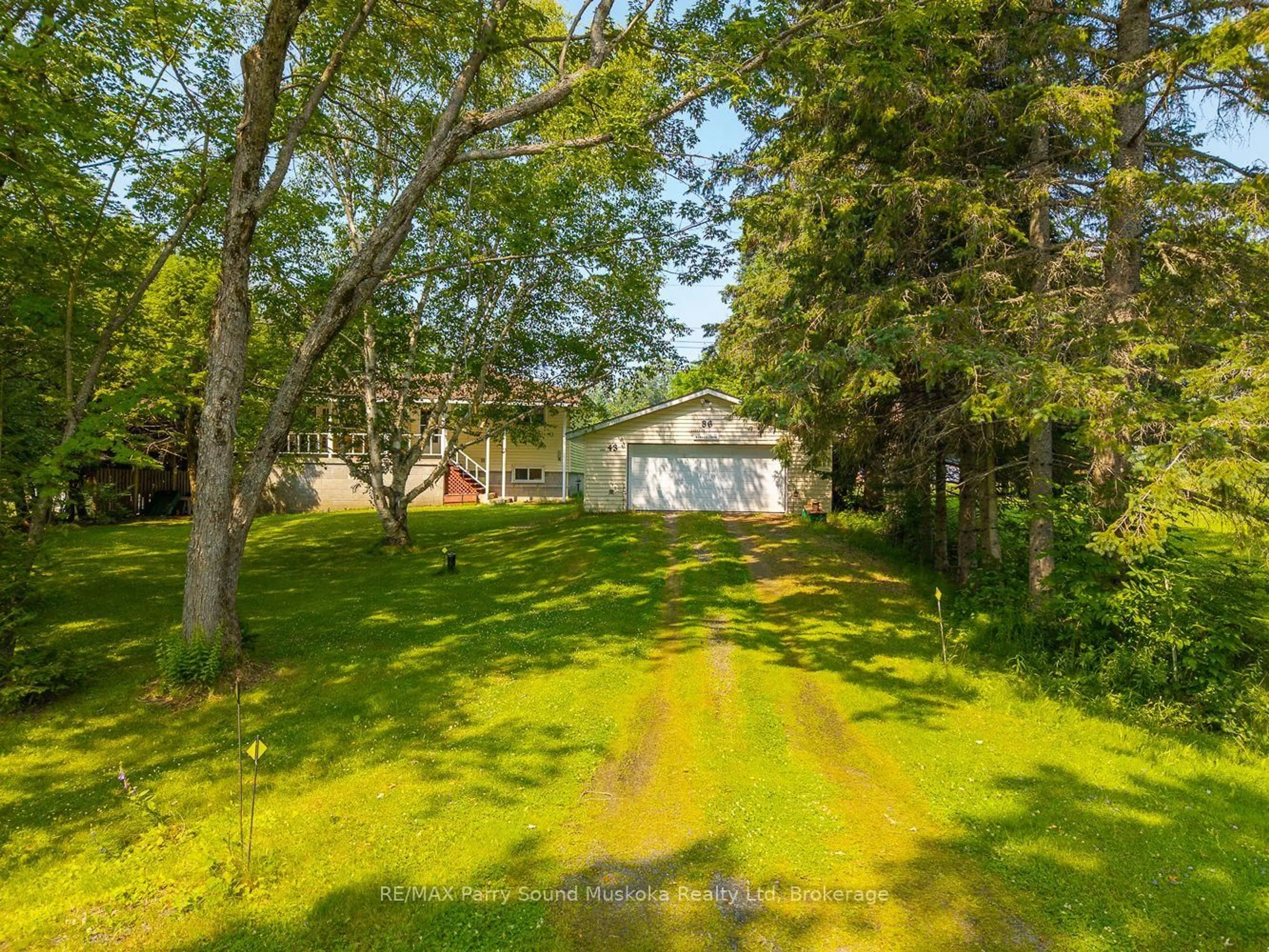 A pic from outside/outdoor area/front of a property/back of a property/a pic from drone, forest/trees view for 86 Lakeside Cres, McKellar Ontario P2A 0B4