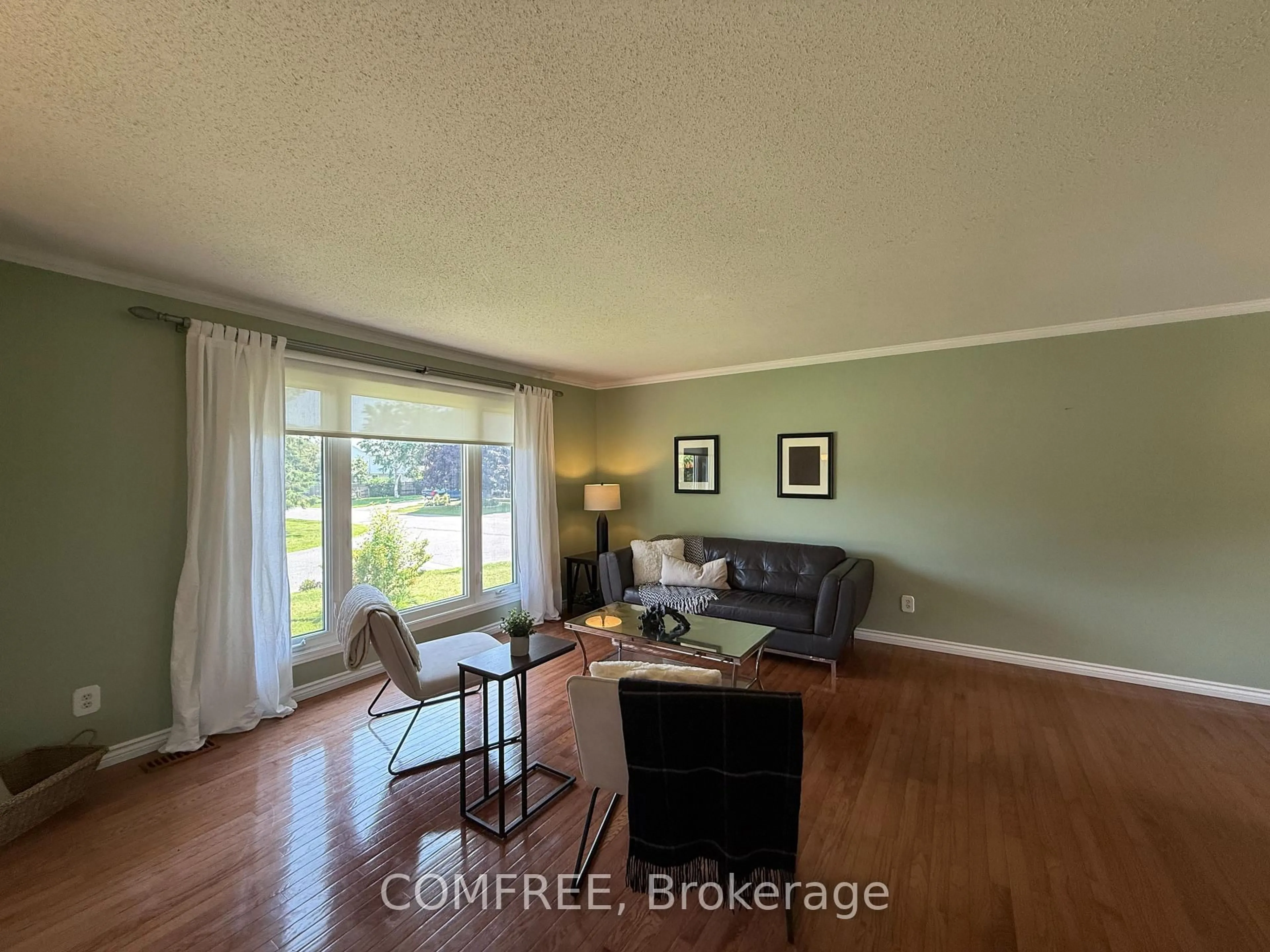 Living room with furniture, wood/laminate floor for 64 Menard St, Russell Ontario K0A 1W1