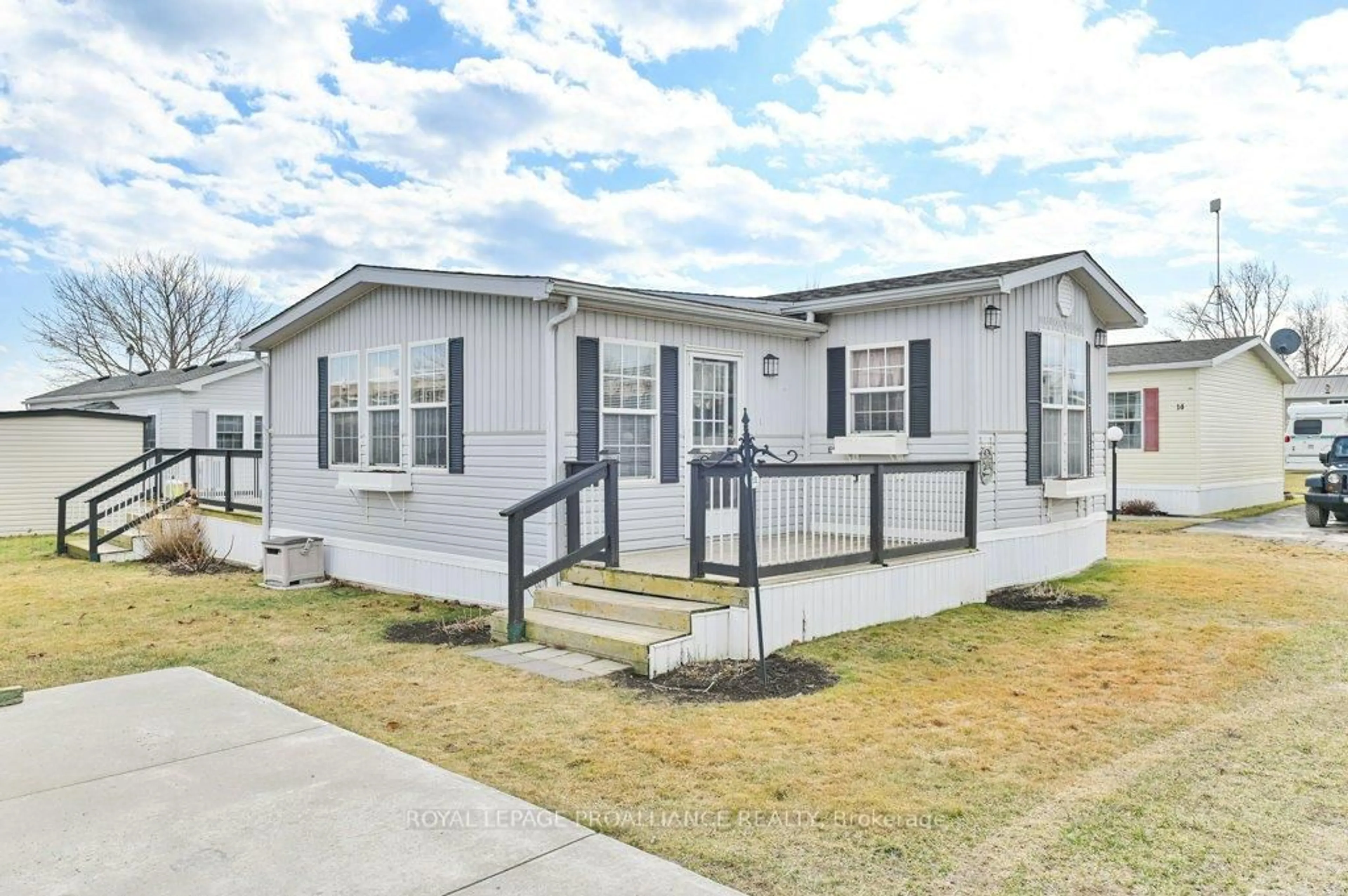 Home with vinyl exterior material, street for 153 County Road 27 #A12, Prince Edward County Ontario K0K 1T0