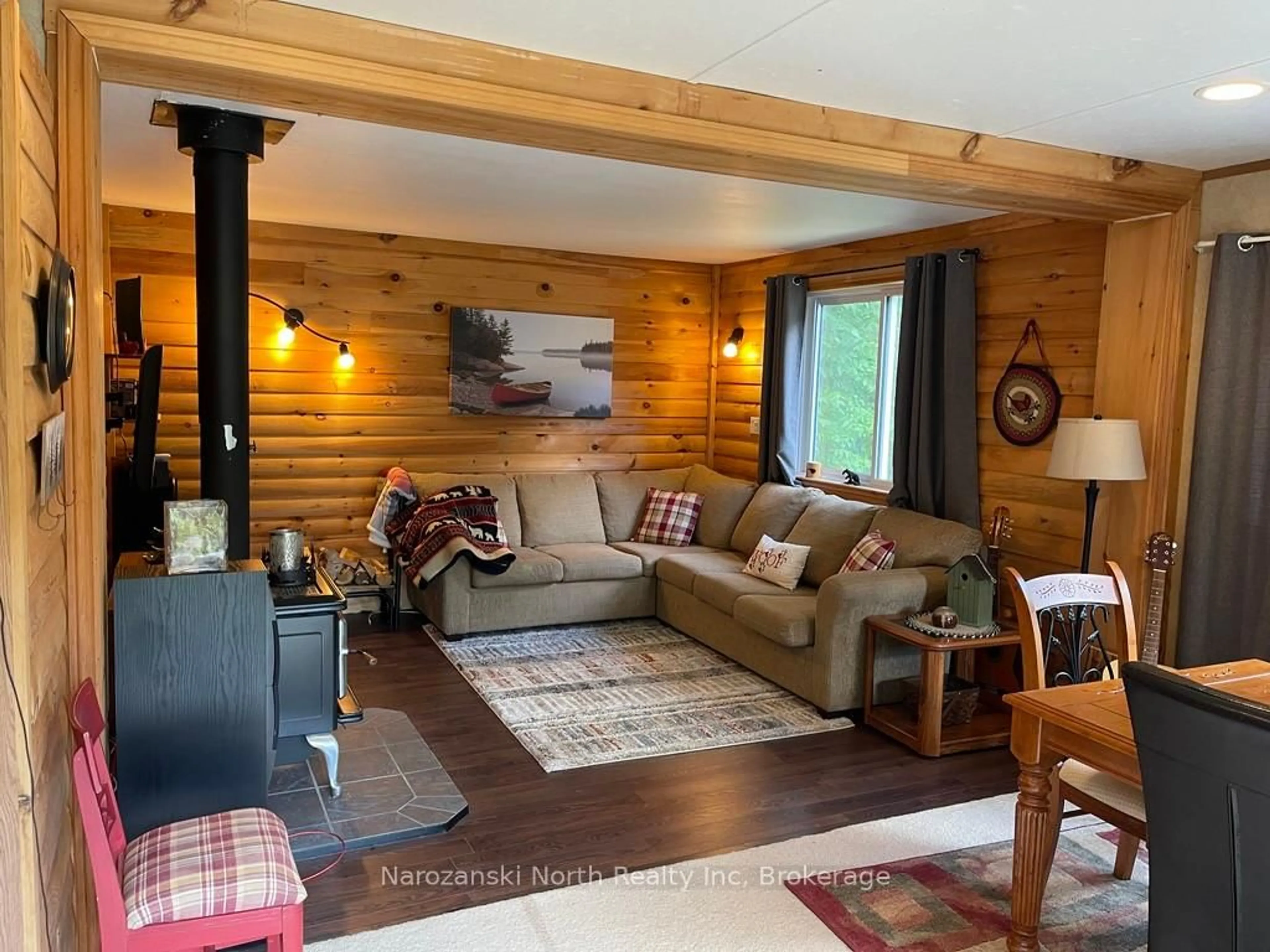 Living room with furniture, wood/laminate floor for 2487 Wolseley Bay Rd, West Nipissing Ontario P0M 2N0