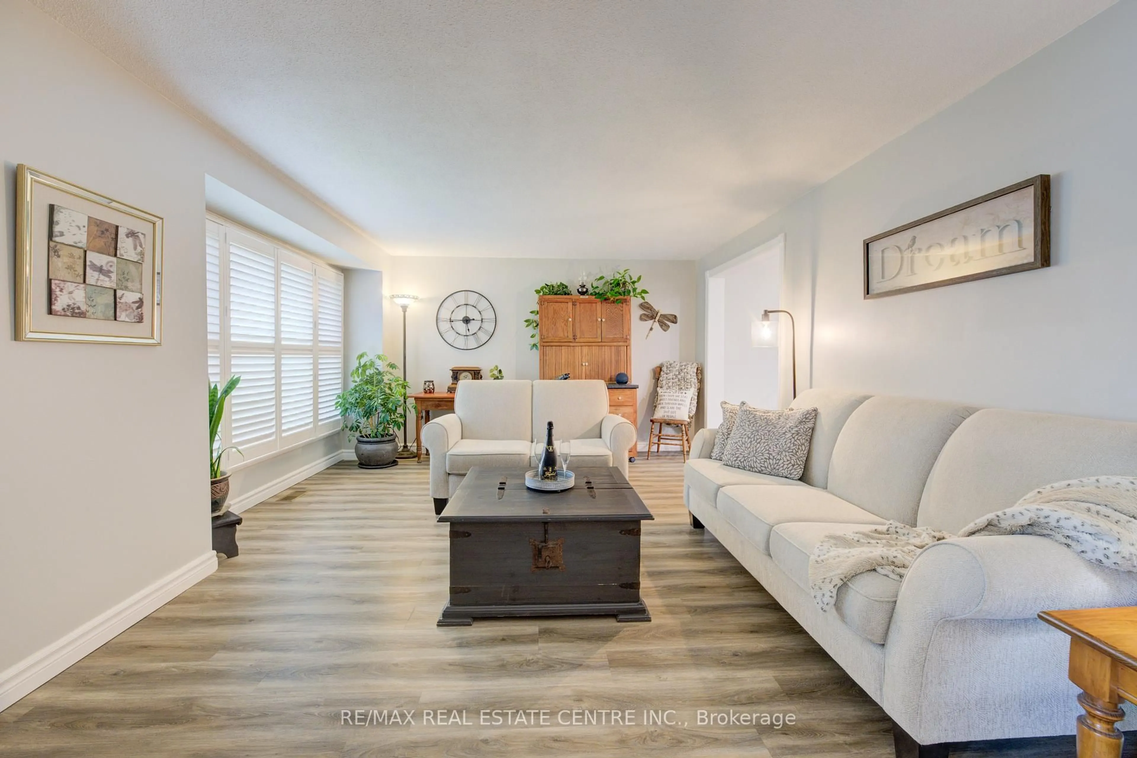Living room with furniture, wood/laminate floor for 96 Manor Dr, Kitchener Ontario N2A 2V1