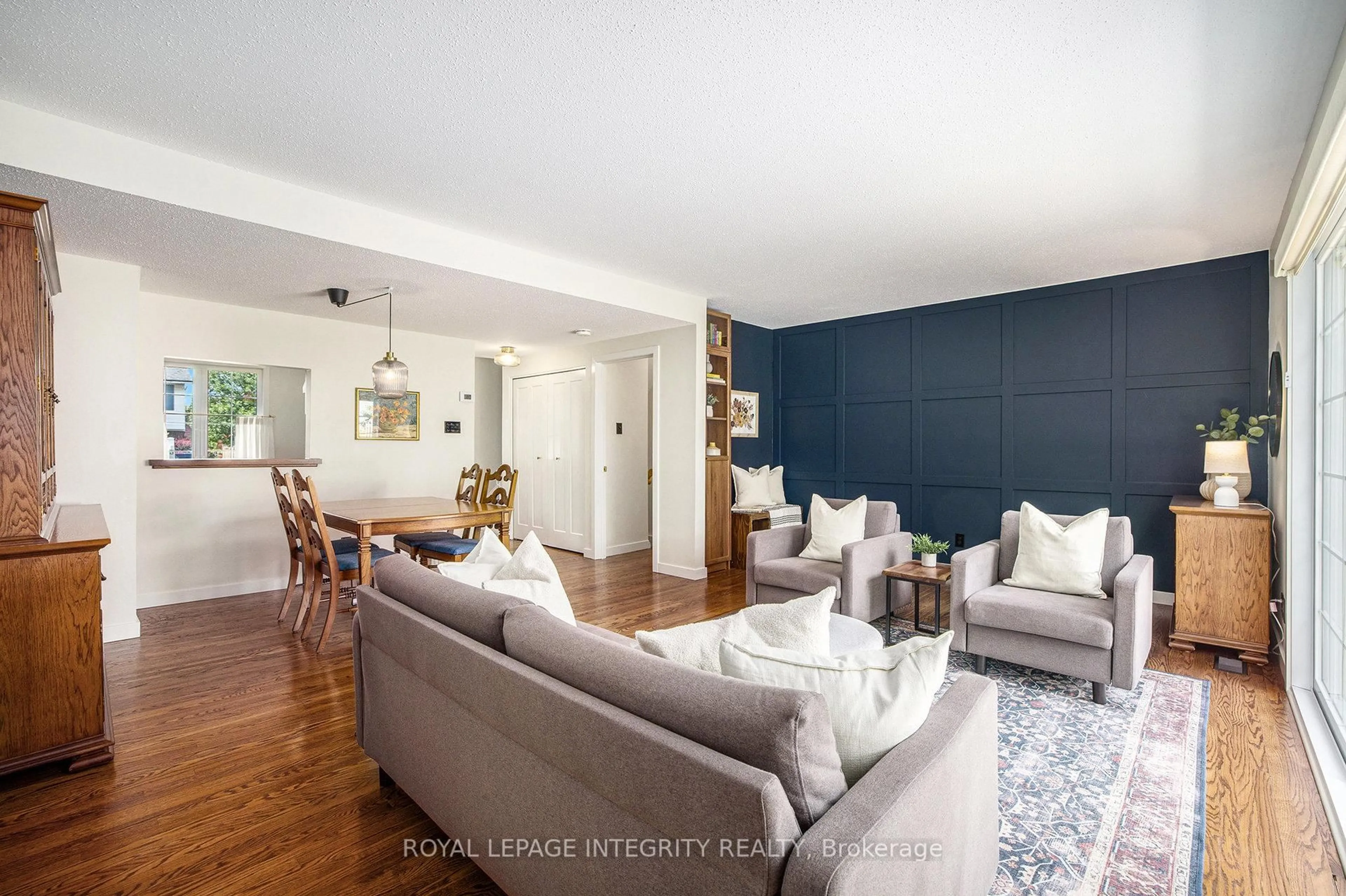 Living room with furniture, wood/laminate floor for 135 Monterey Dr, Ottawa Ontario K2H 7A9