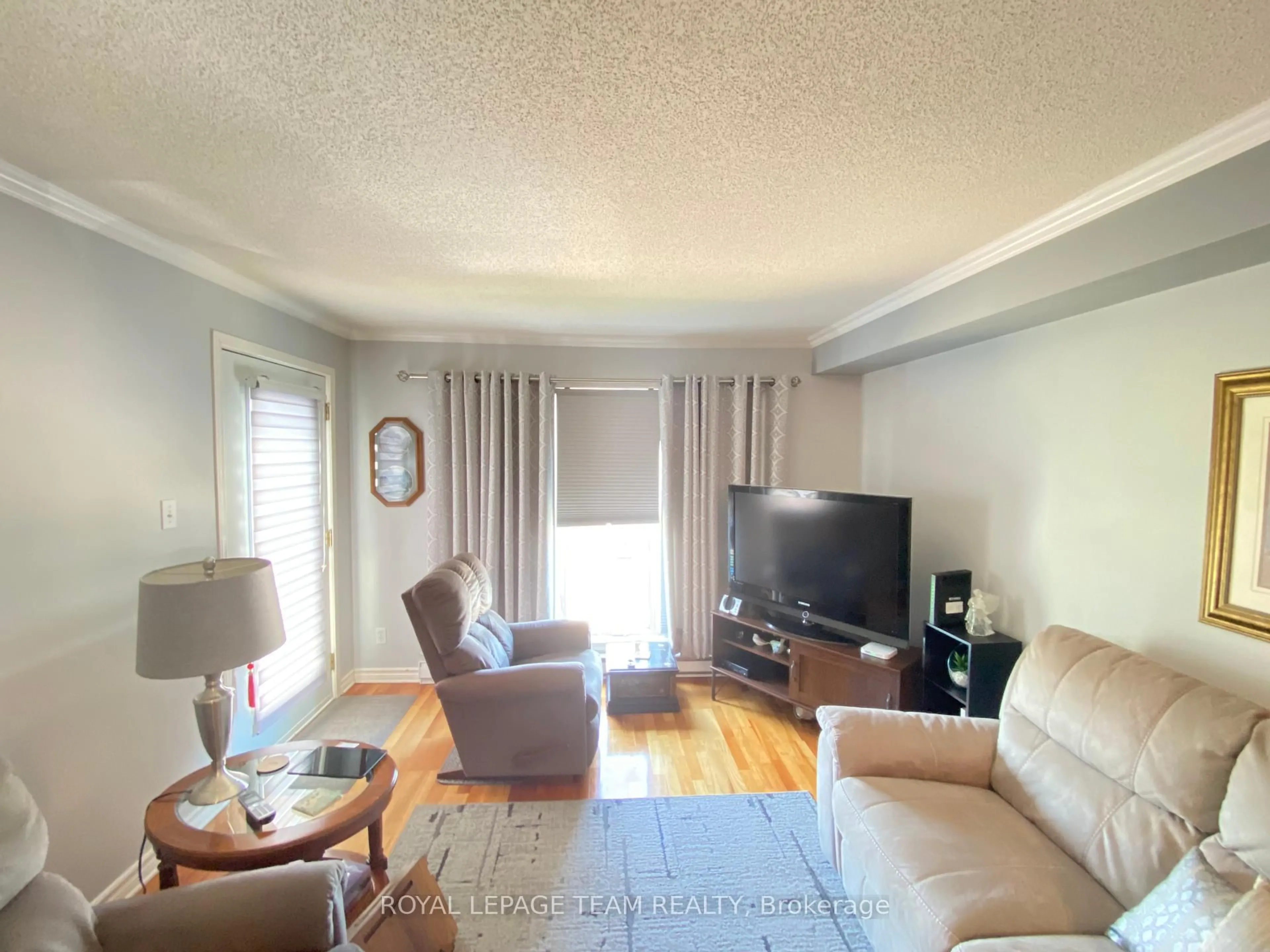 Living room with furniture, wood/laminate floor for 16 Sheffield St #303, Arnprior Ontario K7S 0A2