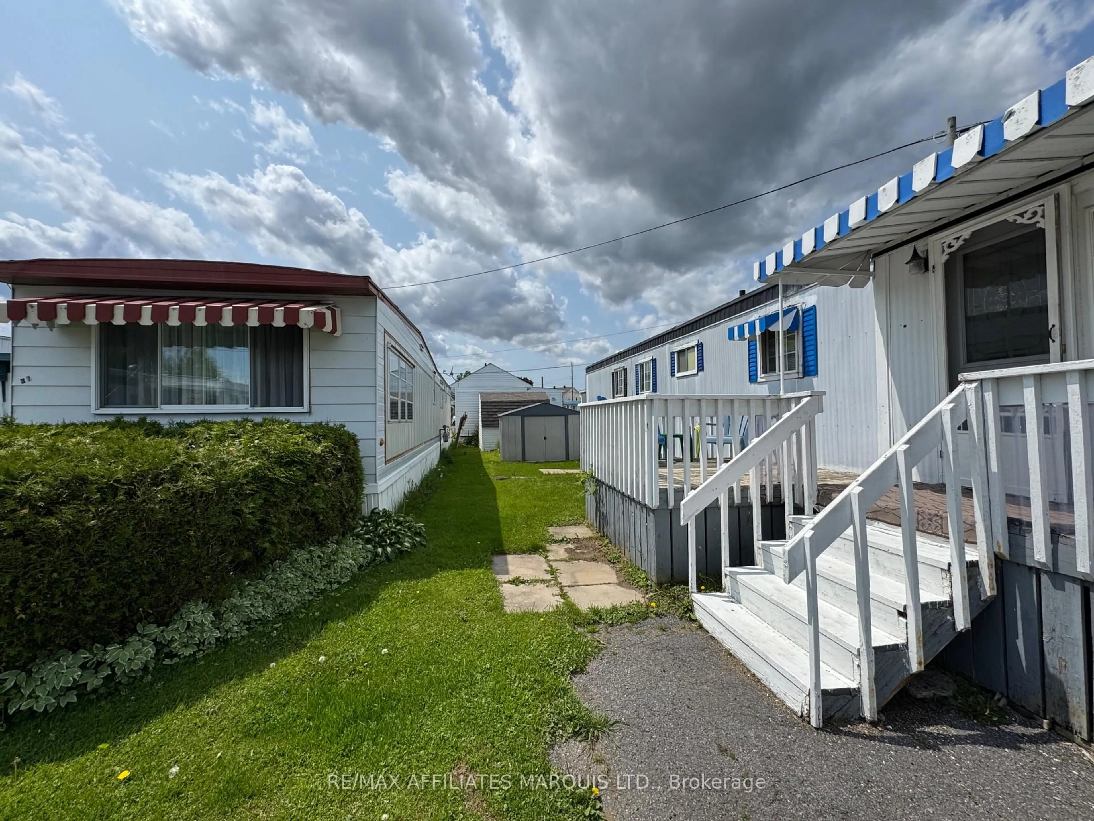 A pic from outside/outdoor area/front of a property/back of a property/a pic from drone, street for 25 County Road 31 Rd #38, South Dundas Ontario K0C 1X0