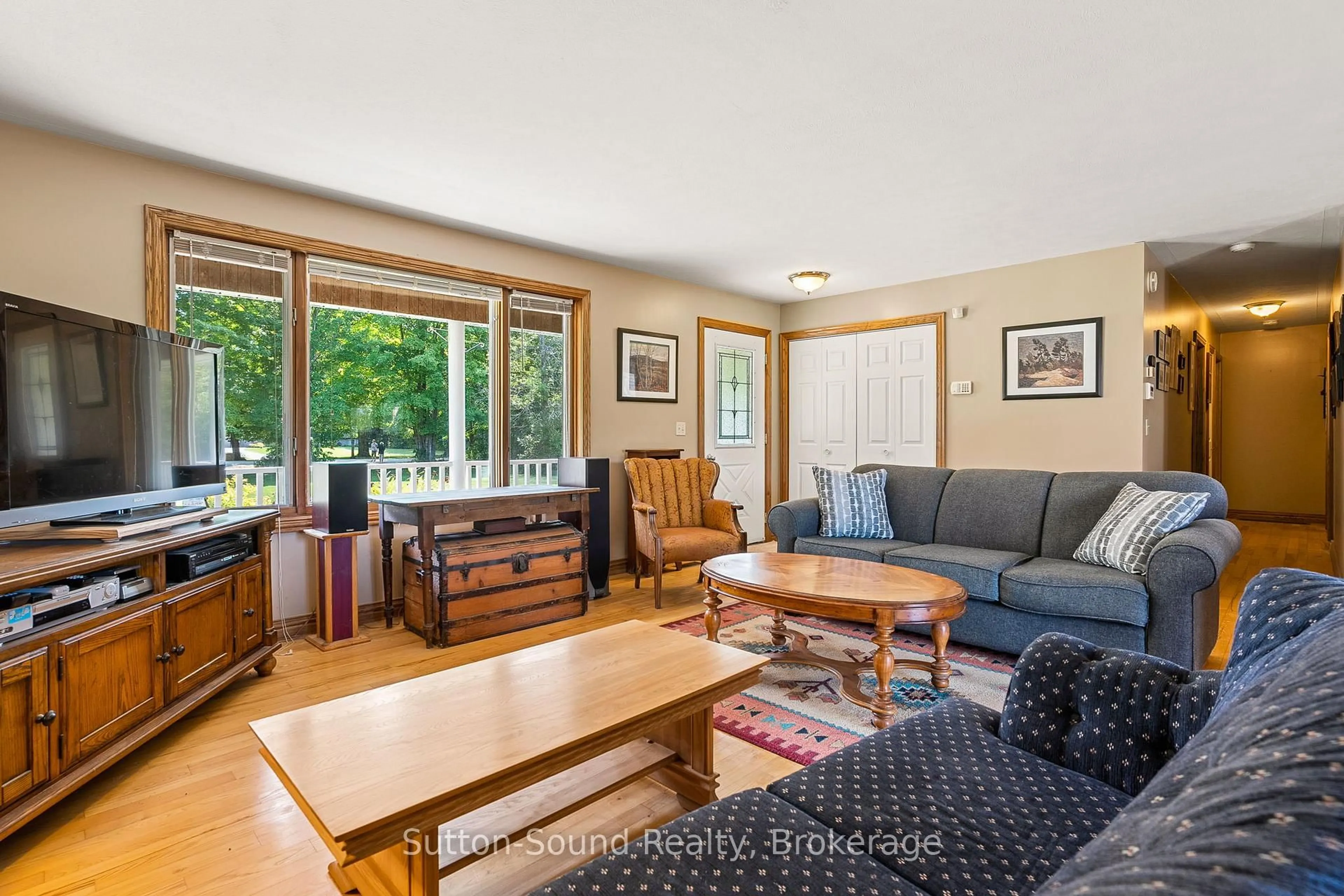 Living room with furniture, wood/laminate floor for 70384 Zion Church Rd, Georgian Bluffs Ontario N0H 2T0