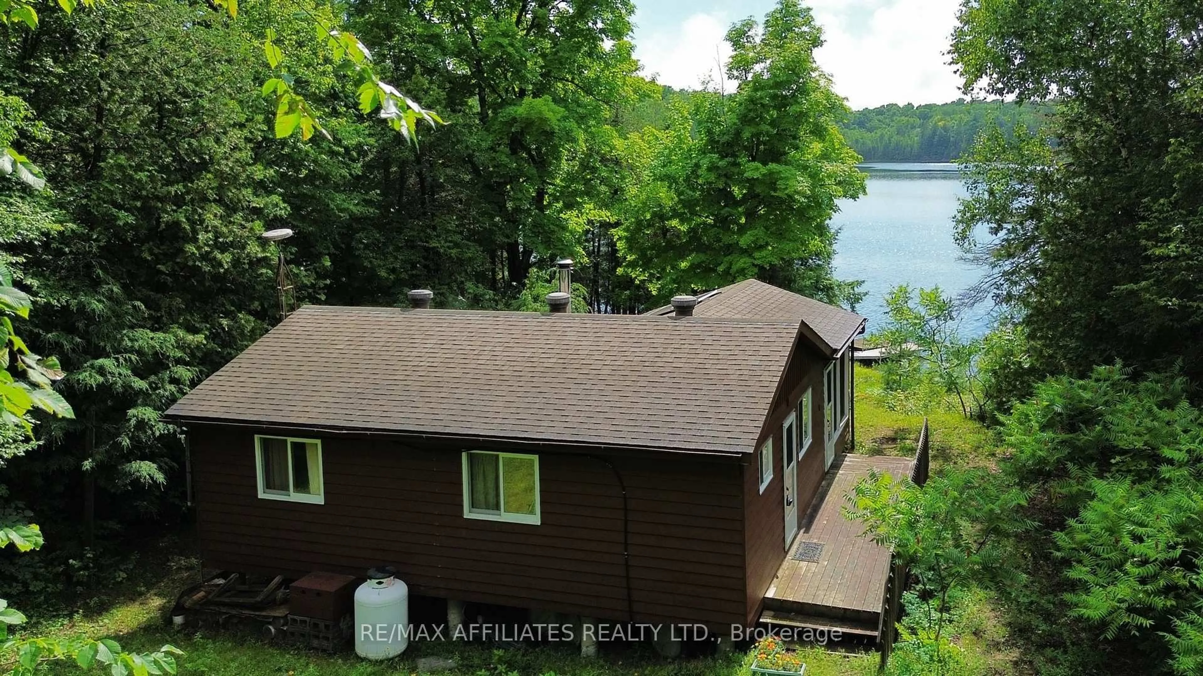 A pic from outside/outdoor area/front of a property/back of a property/a pic from drone, water/lake/river/ocean view for 1015 Penyck  Lake Lane, Sharbot Lake Ontario K0H 2P0