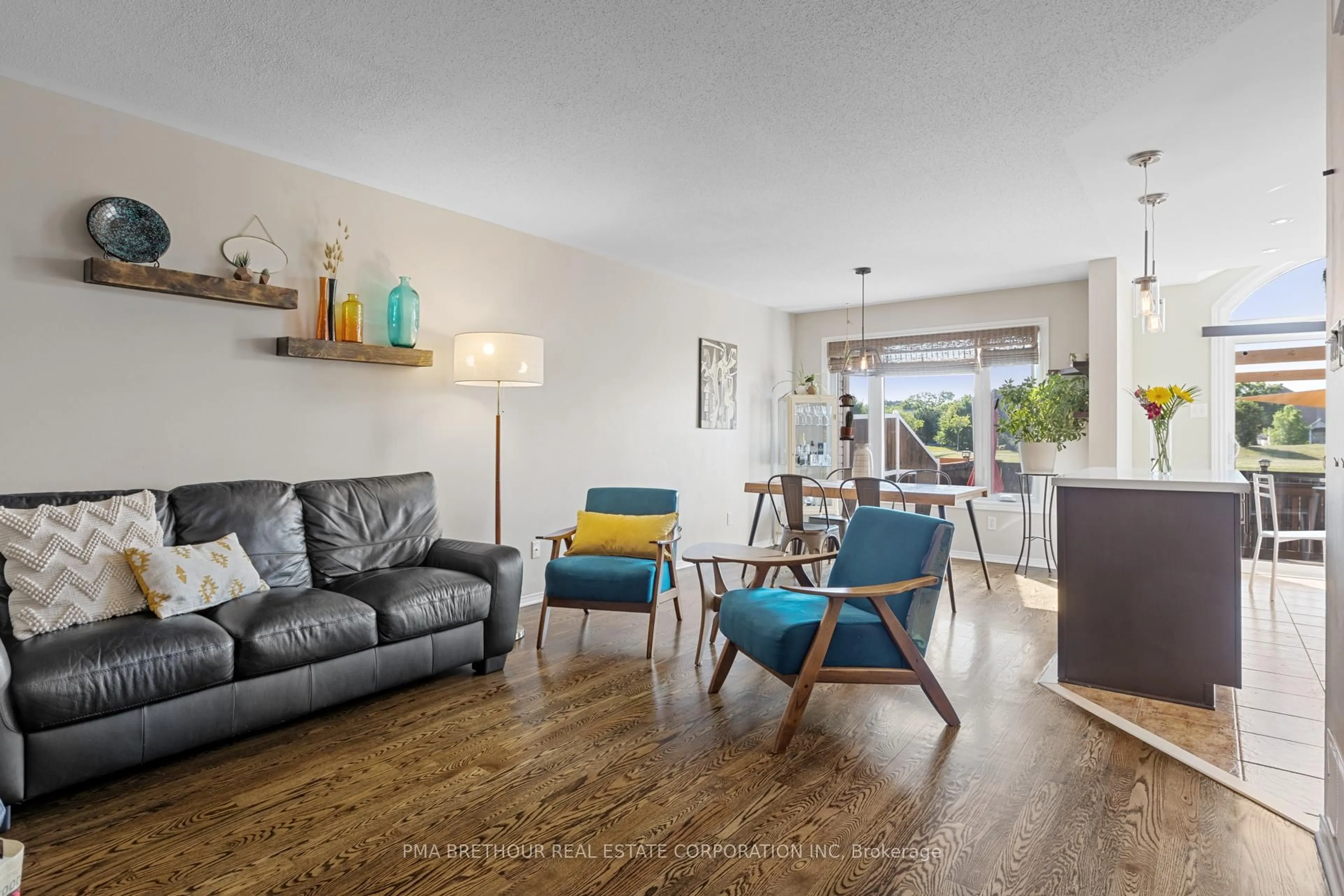Living room with furniture, wood/laminate floor for 572 Renaissance Dr, Ottawa Ontario K4A 4E9