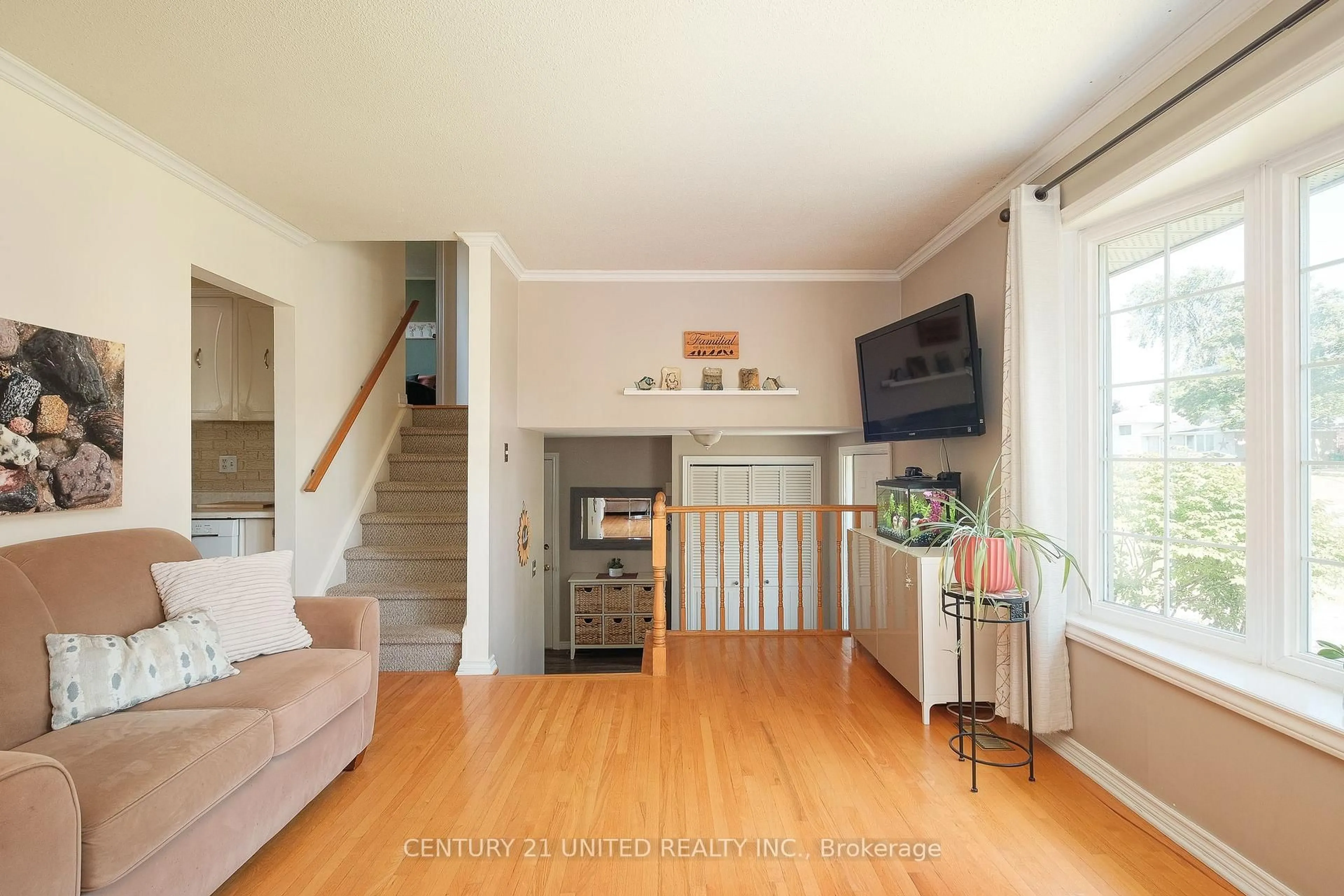 Living room with furniture, wood/laminate floor for 888 Sydenham Rd, Peterborough South Ontario K9J 1K2