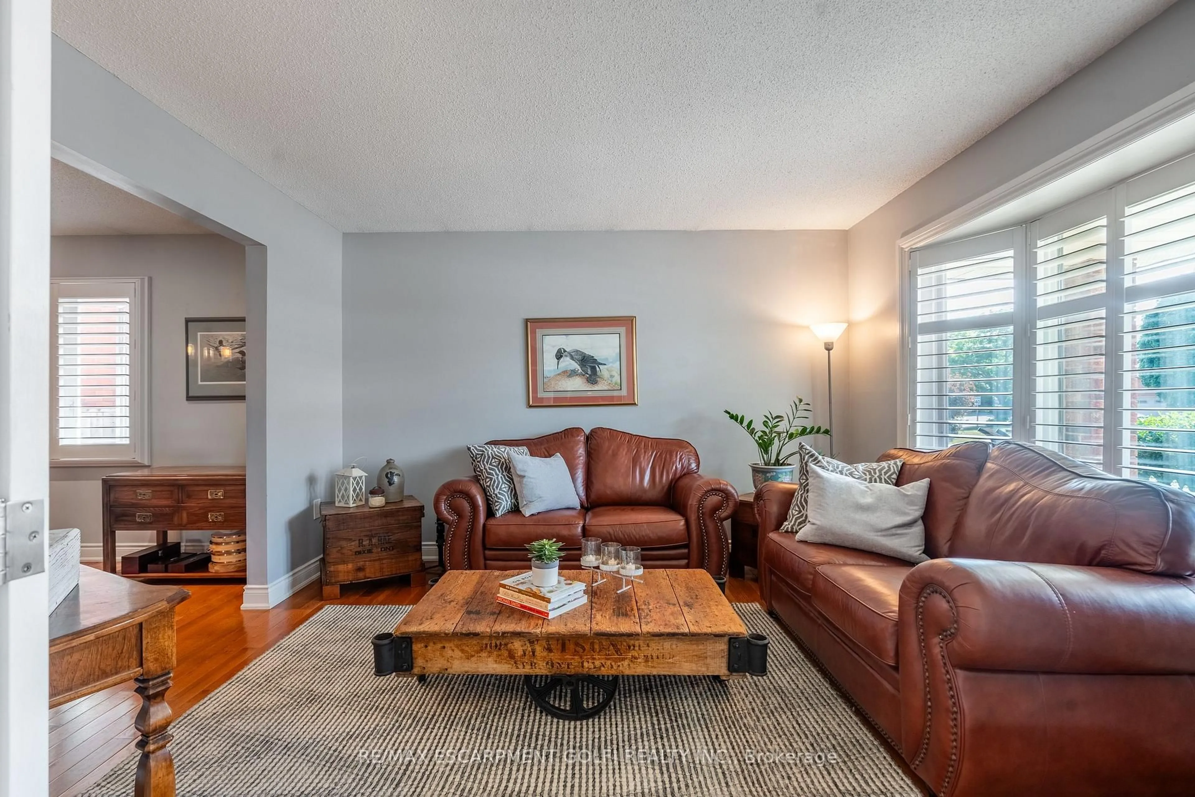 Living room with furniture, wood/laminate floor for 190 Brigade Dr, Hamilton Ontario L9B 2G4