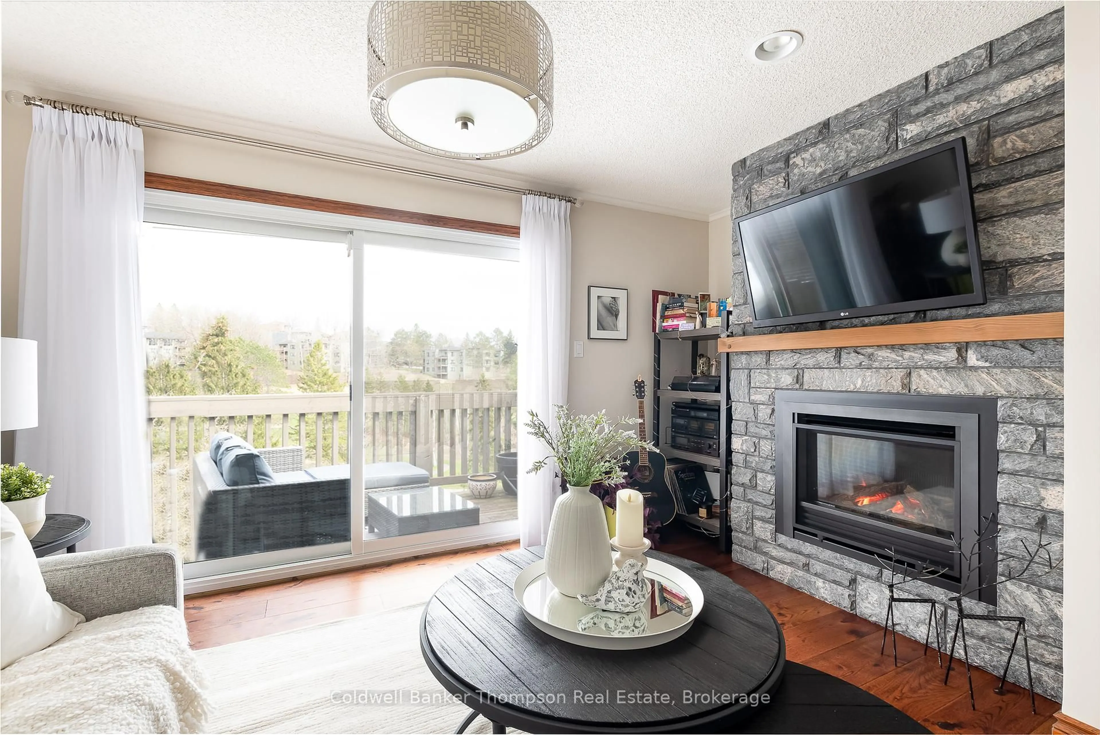 Living room with furniture, wood/laminate floor for 34 Deerhurst Greens Rd #301, Huntsville Ontario P1H 1A9