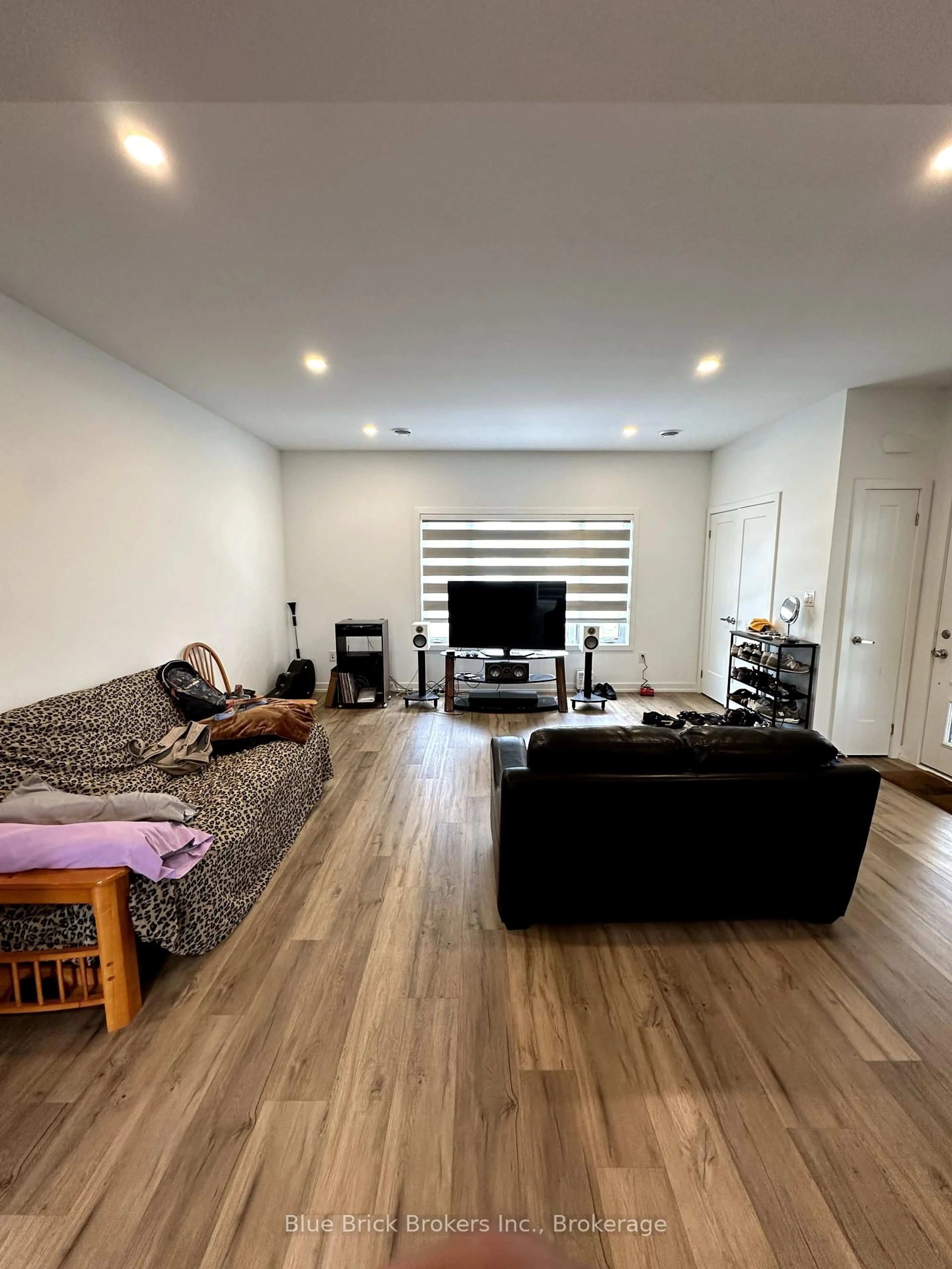 Living room with furniture, wood/laminate floor for 4263 Fourth Ave #121, Niagara Falls Ontario L2E 0C2