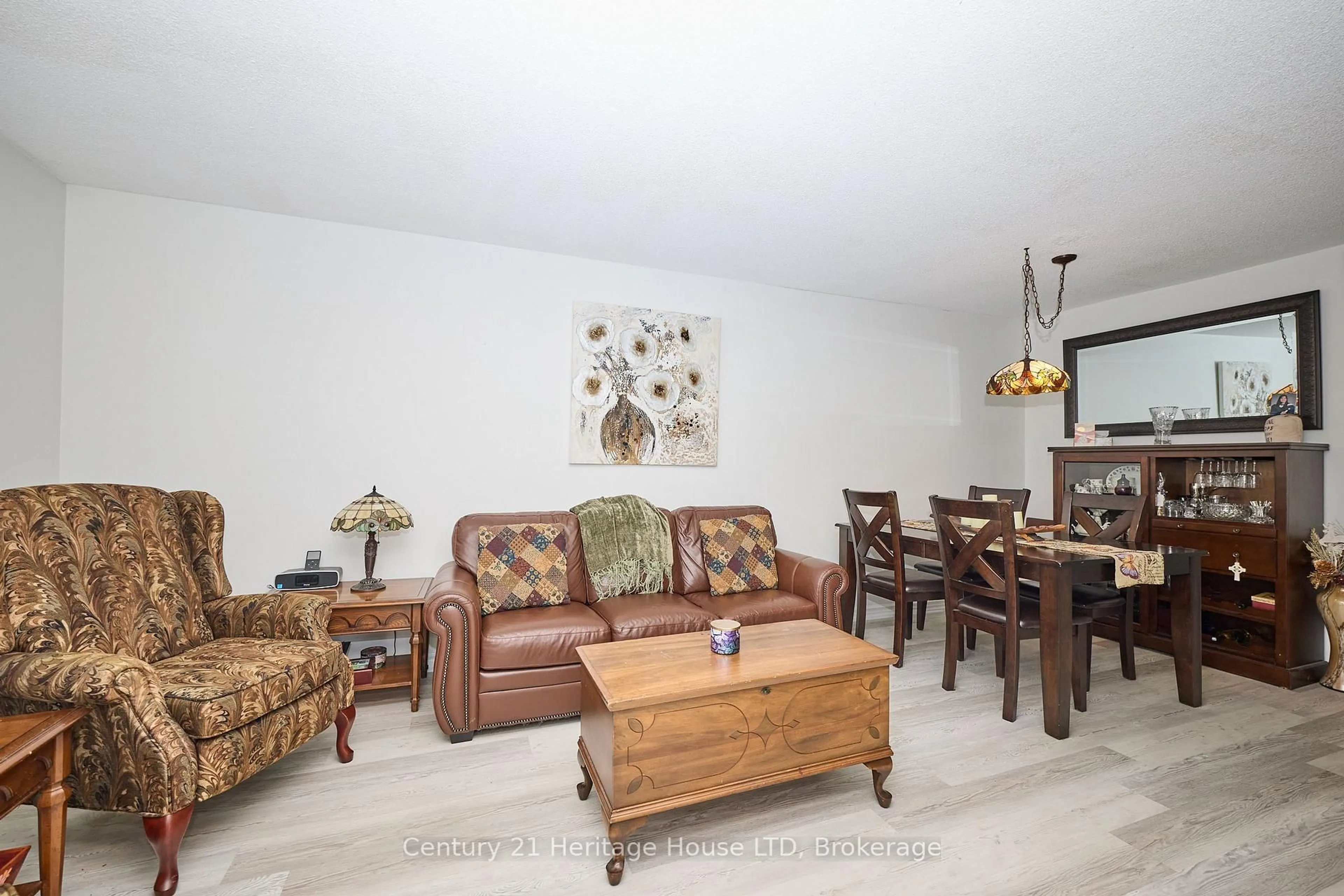 Living room with furniture, wood/laminate floor for 226 Vansickle Rd #12, St. Catharines Ontario L2S 2S7