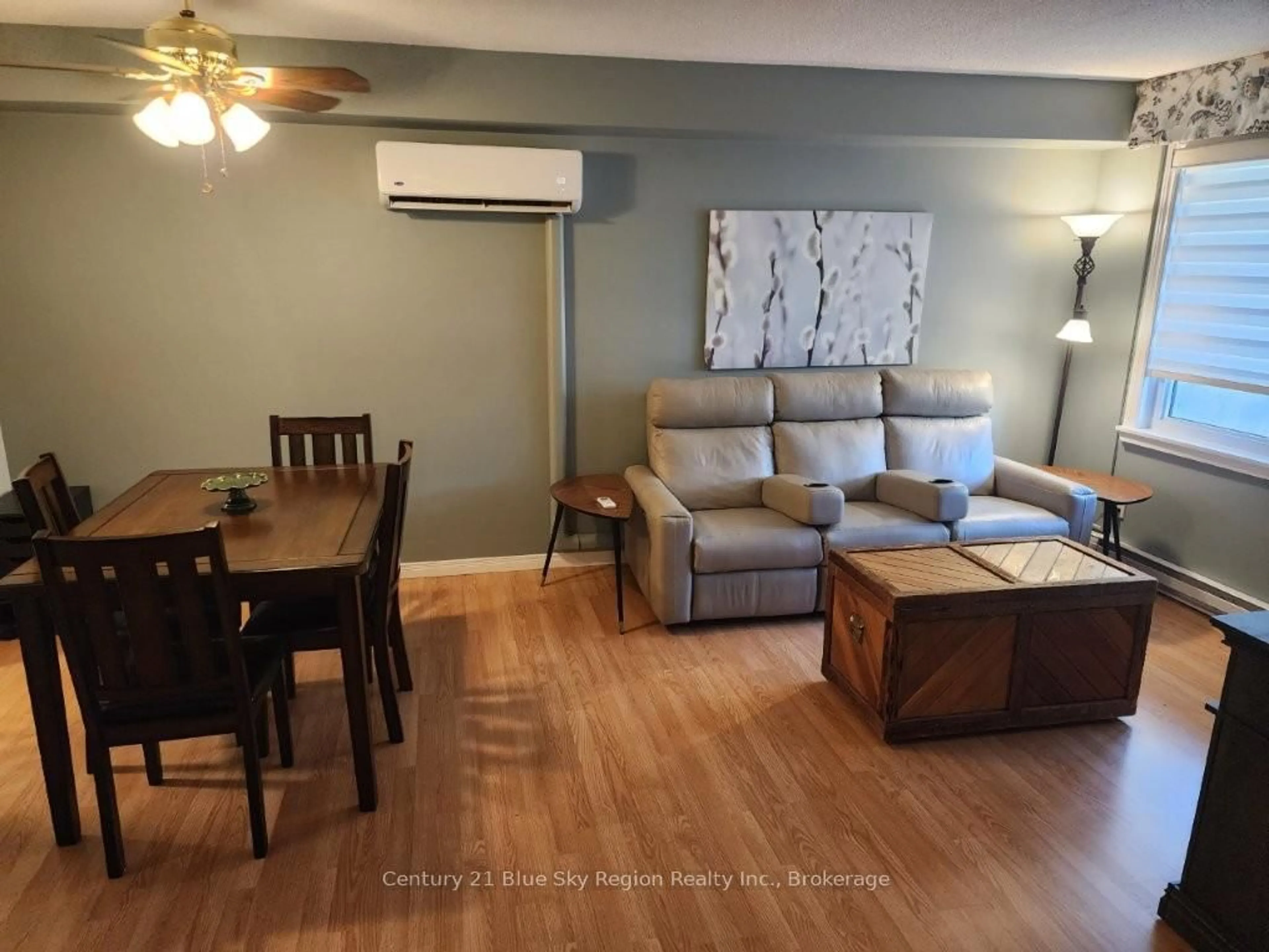 Living room with furniture, wood/laminate floor for 130 Worthington St #405, North Bay Ontario P1B 3B2