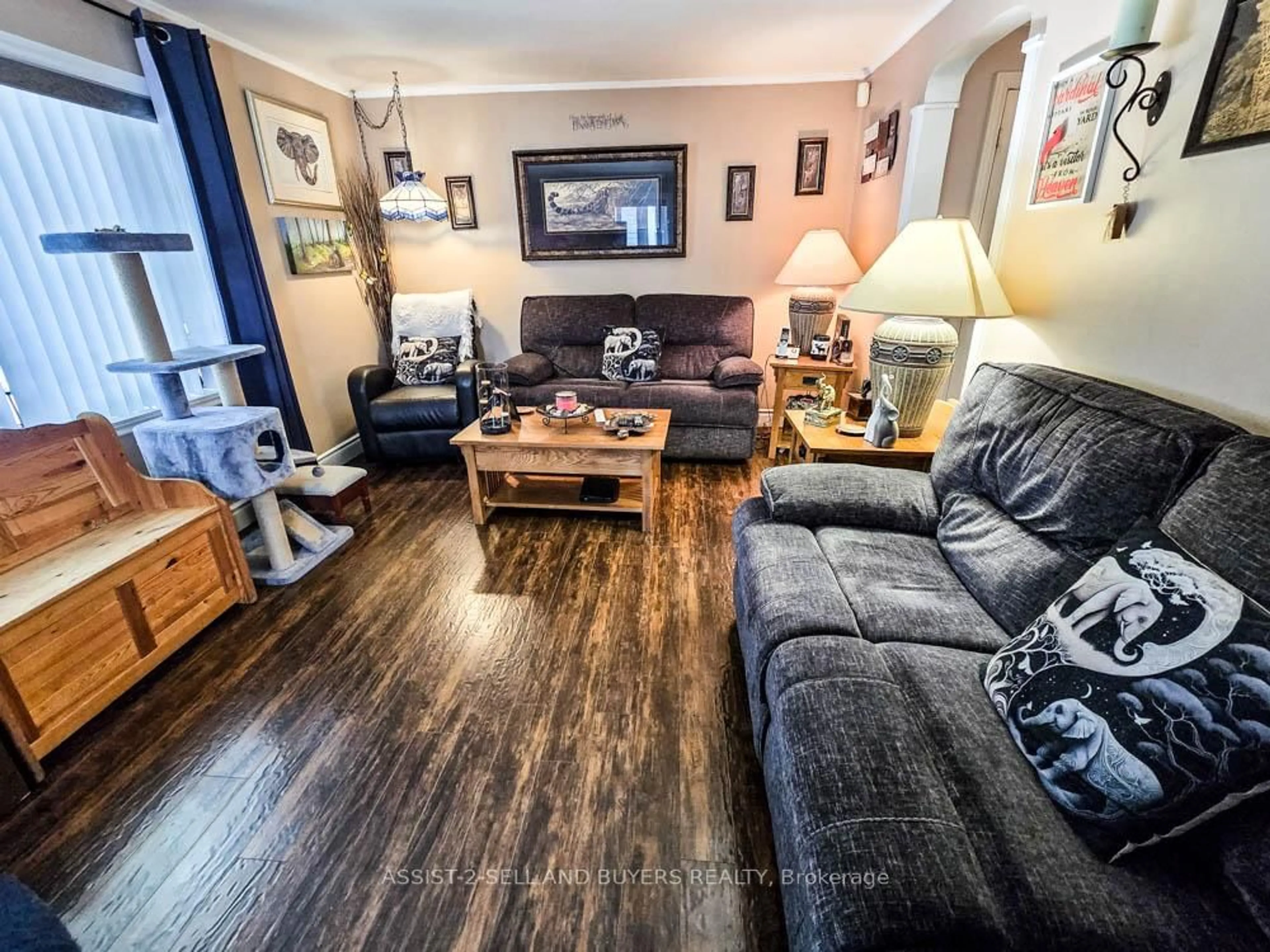 Living room with furniture, wood/laminate floor for 23 Monroe Ave, Cornwall Ontario K6H 2N1