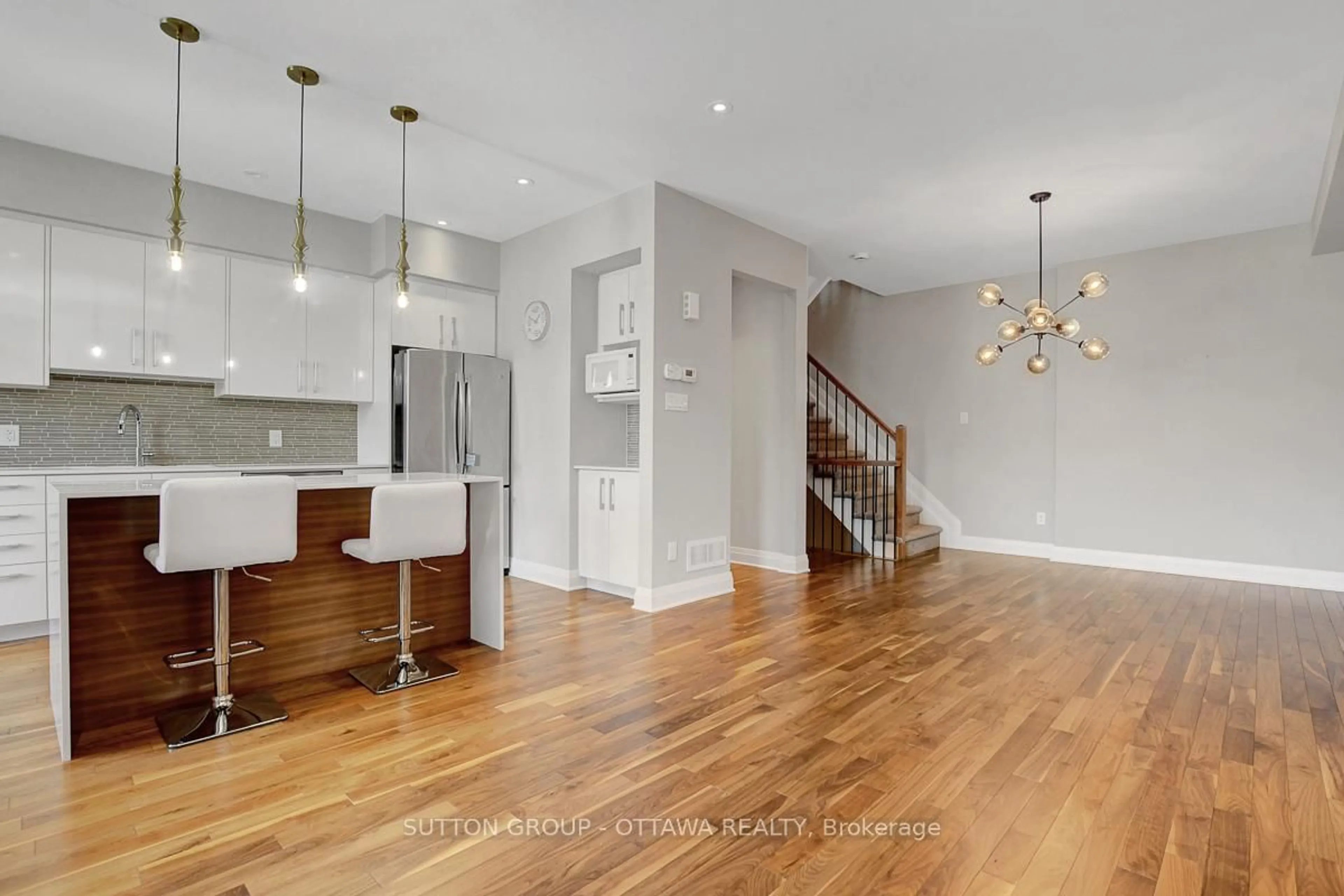 Open concept kitchen, wood/laminate floor for 120 Nutting Cres, Ottawa Ontario K4M 0C3