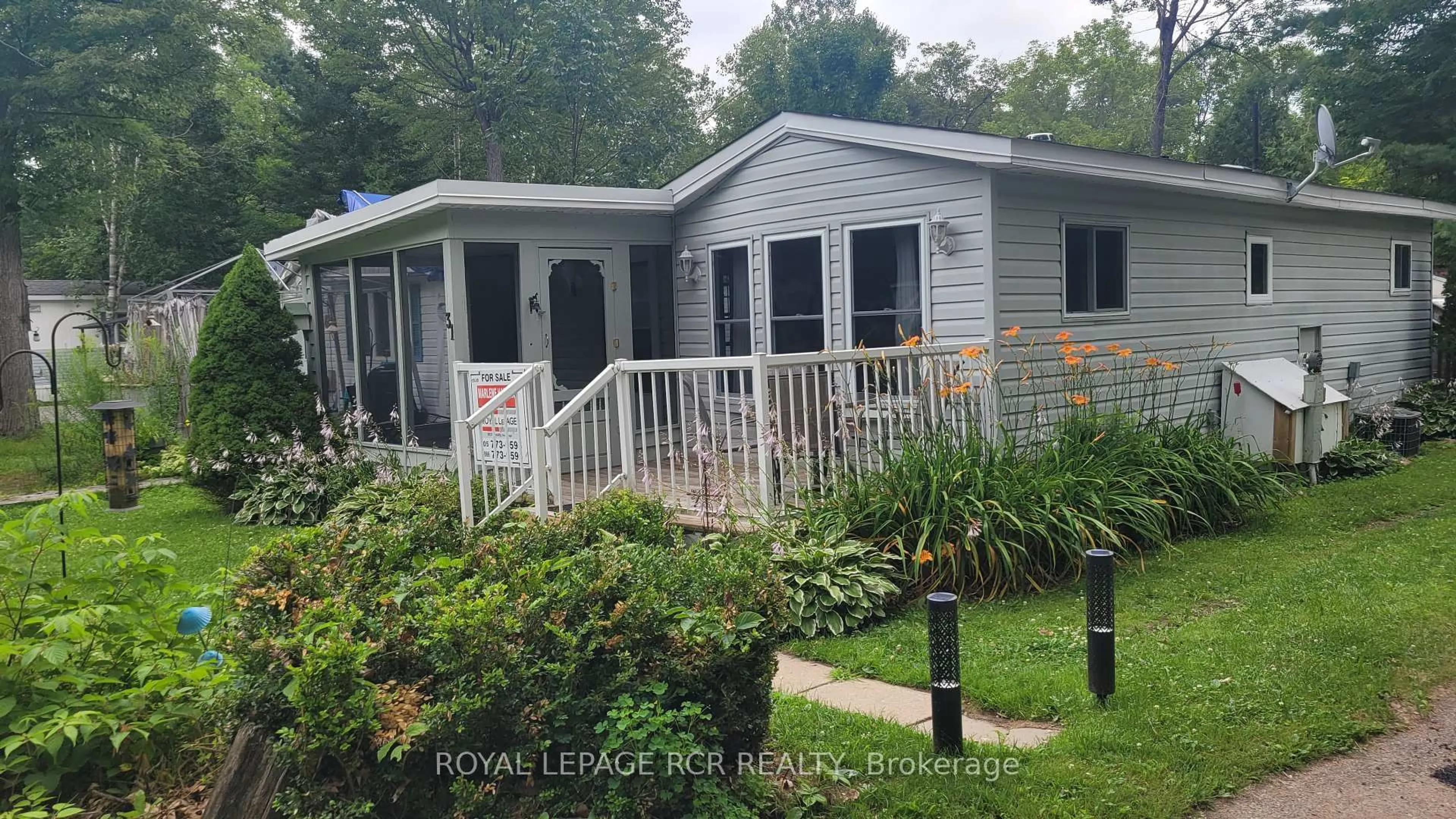 Home with vinyl exterior material, street for 1007 Racoon Rd #31, Gravenhurst Ontario P1P 1R1