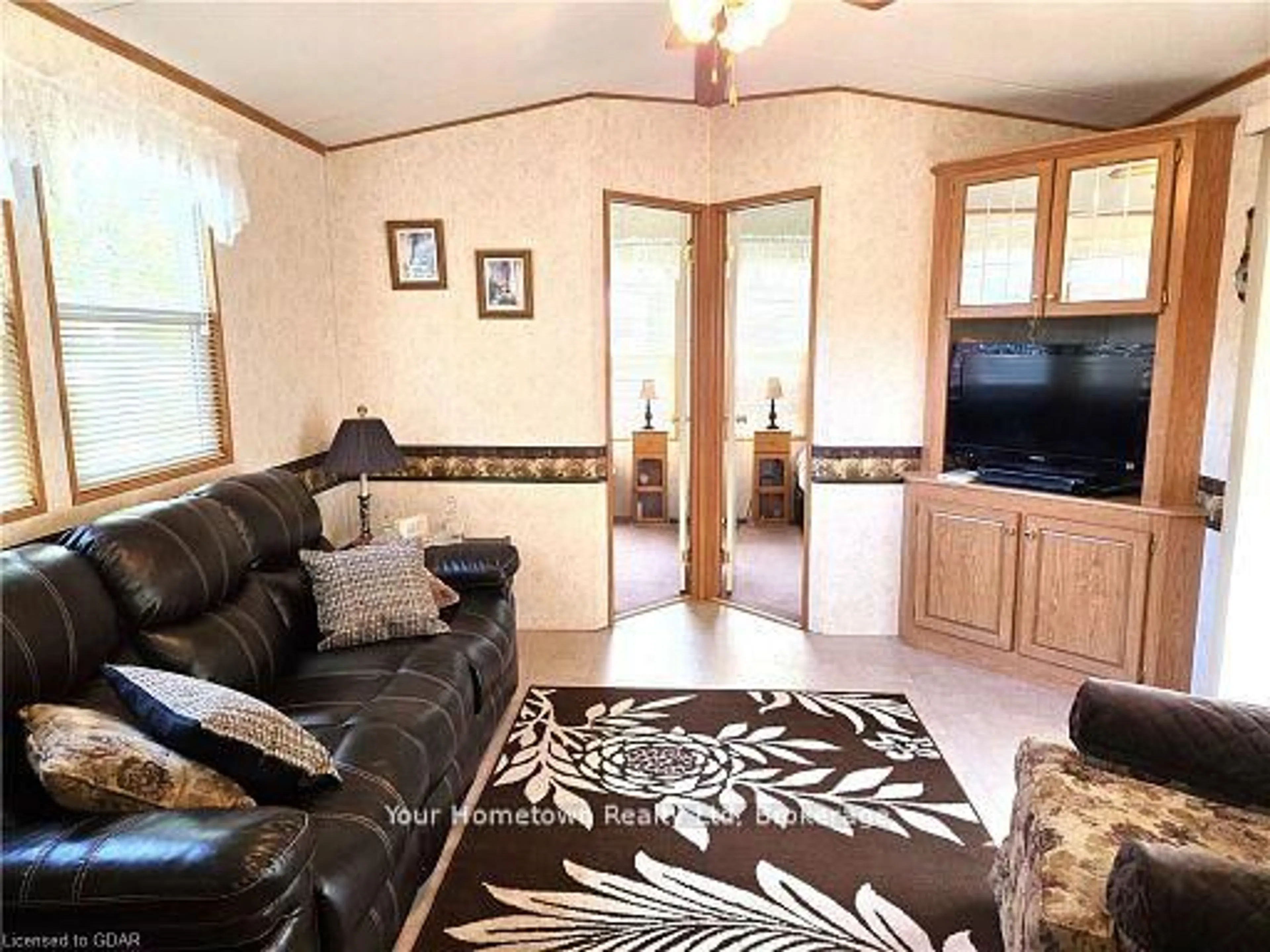 Living room with furniture, wood/laminate floor for 204 Beach Rd, Centre Wellington Ontario N1M 2W5
