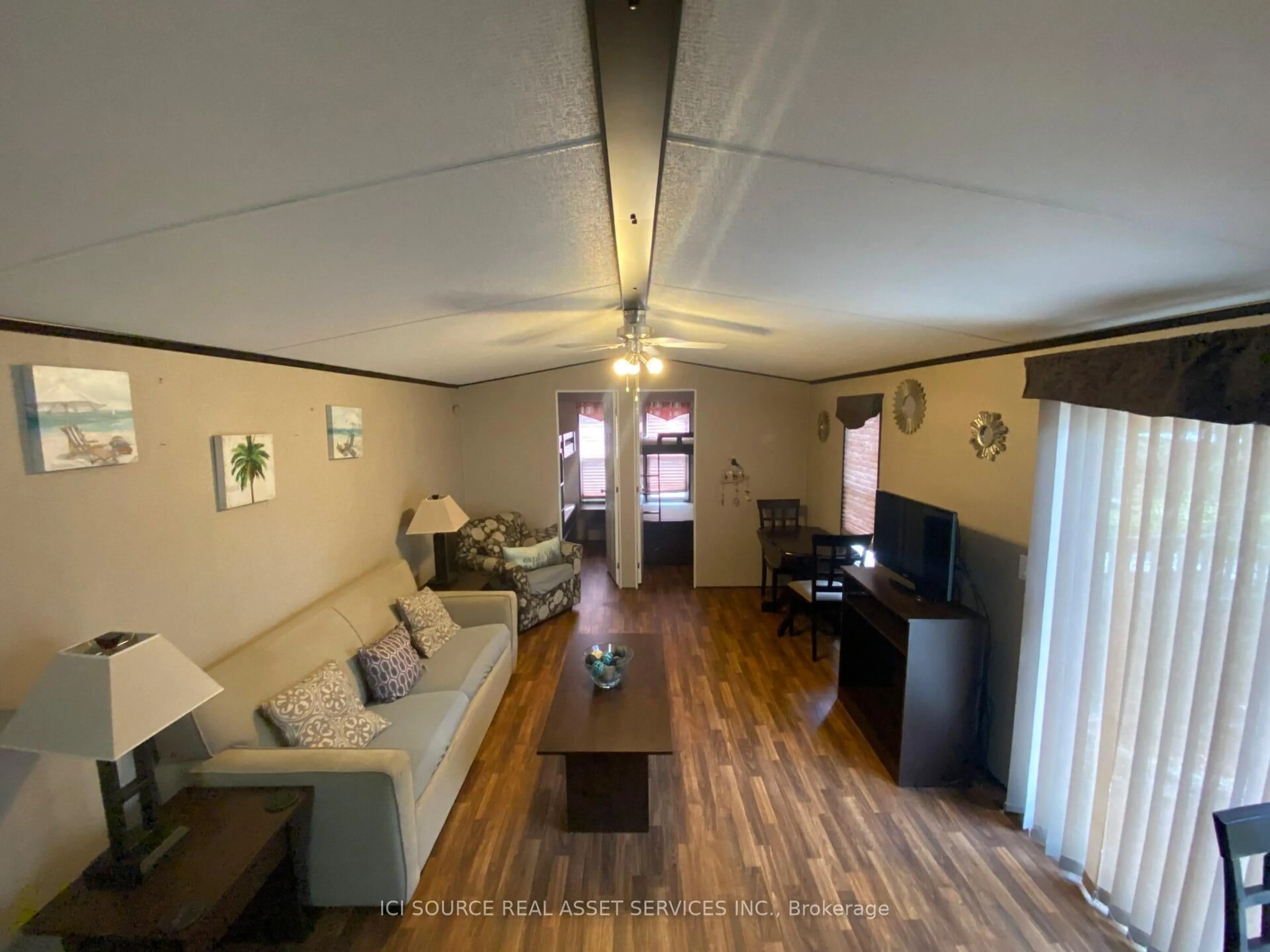 Living room with furniture, wood/laminate floor for 1082 Shamrock Marina Rd #SMR148, Gravenhurst Ontario P0E 1N0