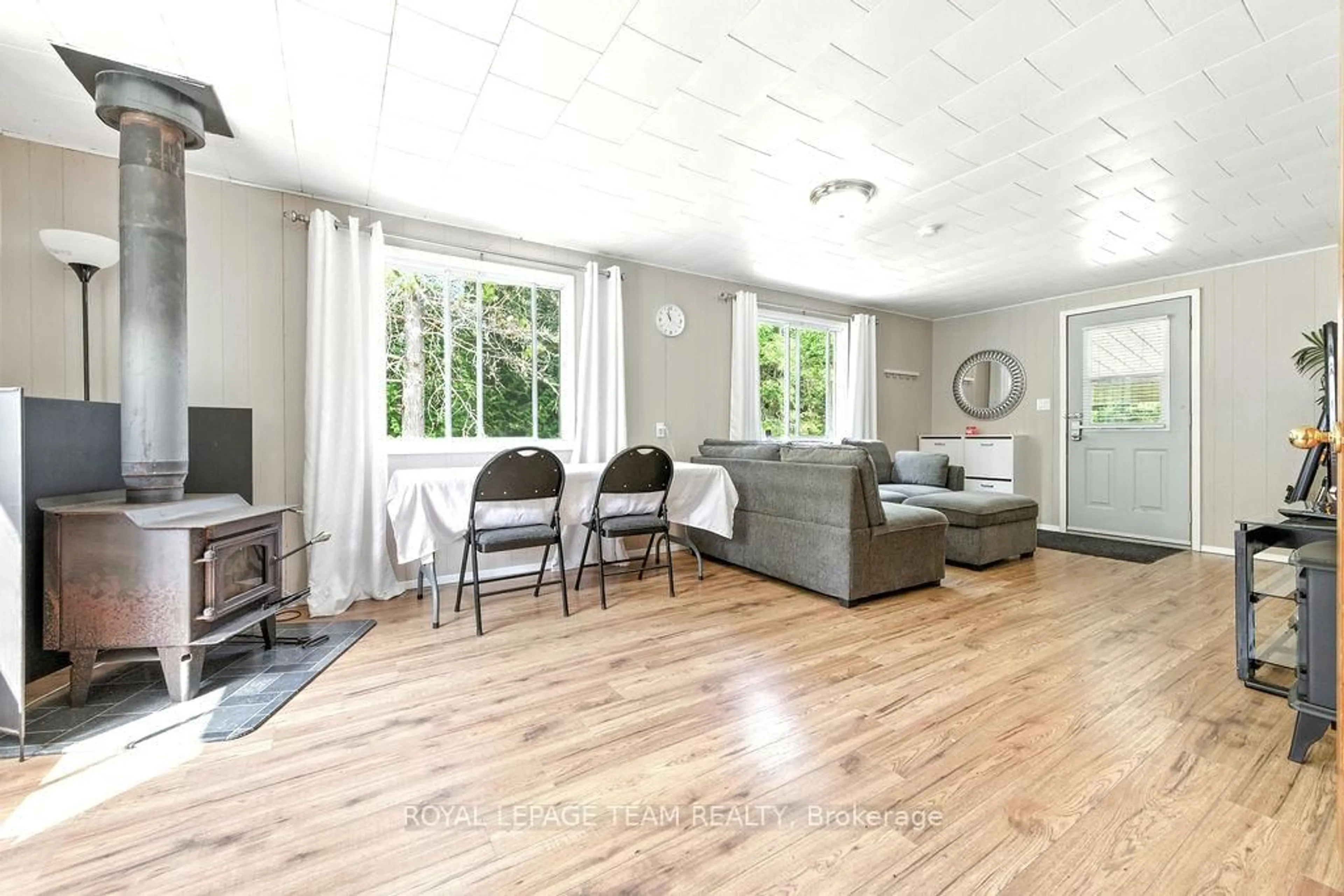 Living room with furniture, wood/laminate floor for 7300 Highway #127 Highway, South Algonquin Ontario K0J 2M0
