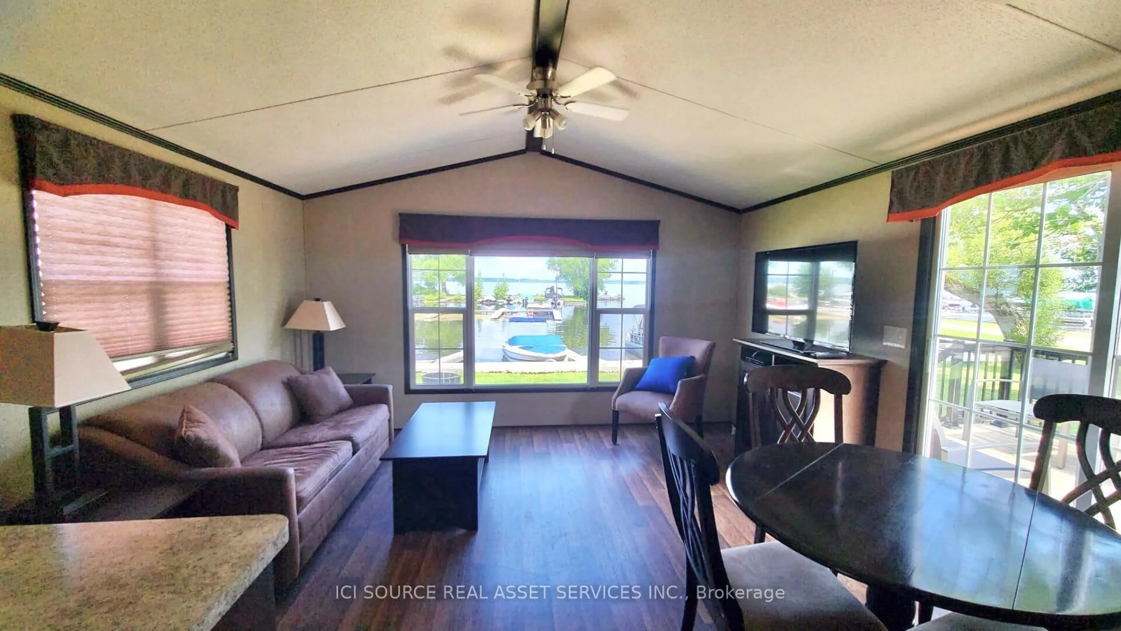 Living room with furniture, wood/laminate floor for 7100 County Rd 18 #SBR03, Alnwick/Haldimand Ontario K0K 2X0