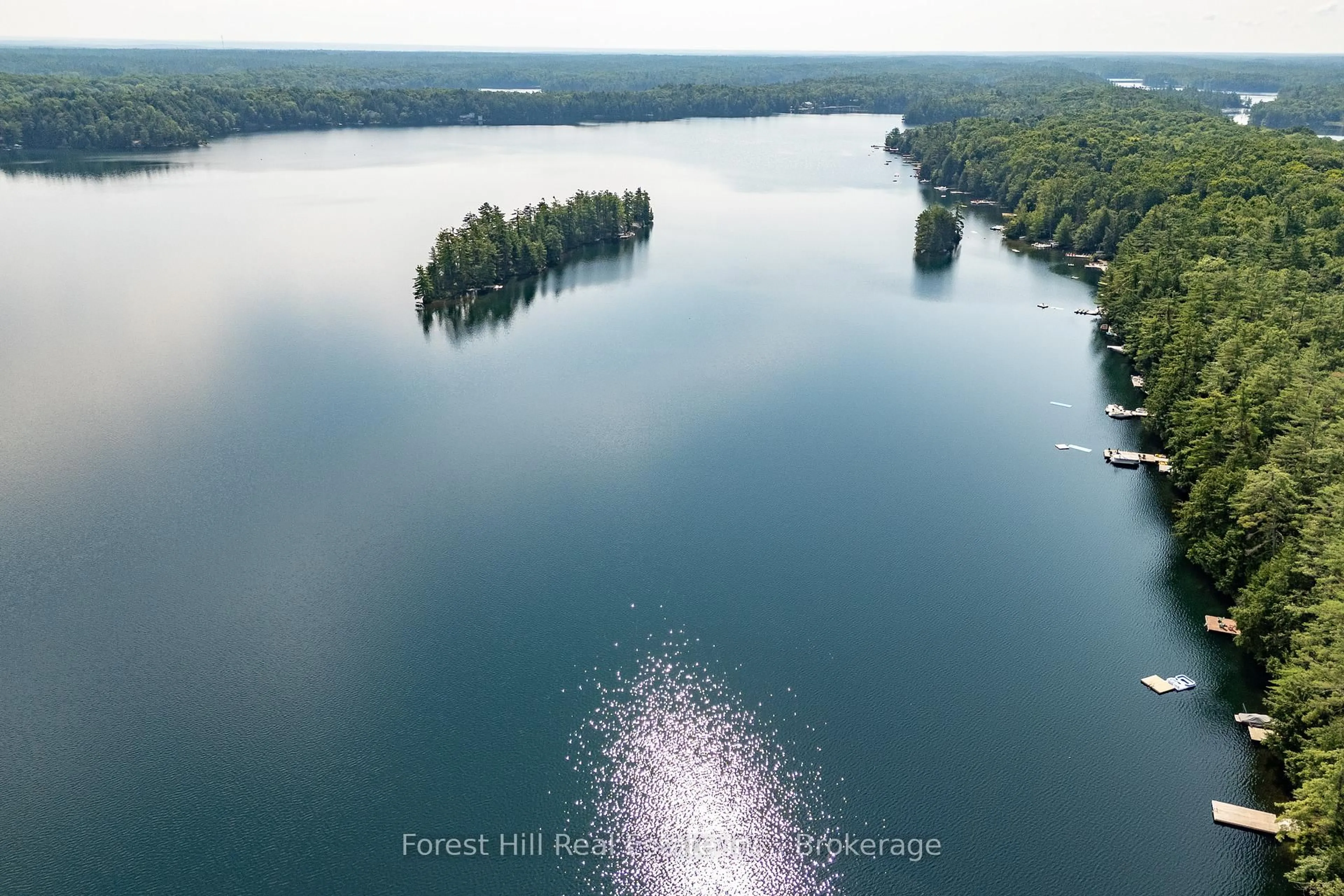 A pic from outside/outdoor area/front of a property/back of a property/a pic from drone, water/lake/river/ocean view for 1029 Ridge Rd, Muskoka Lakes Ontario P0C 1M0