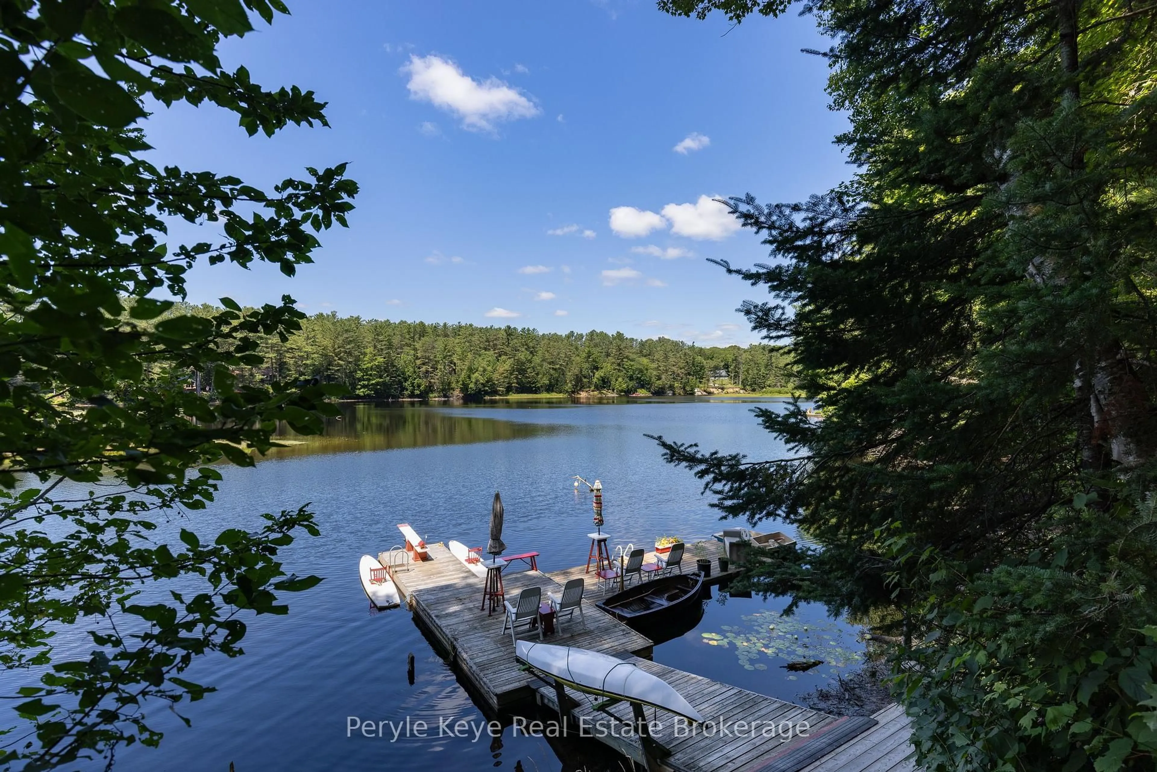 A pic from outside/outdoor area/front of a property/back of a property/a pic from drone, water/lake/river/ocean view for 136 Deer Lake Rd, Huntsville Ontario P0B 1L0