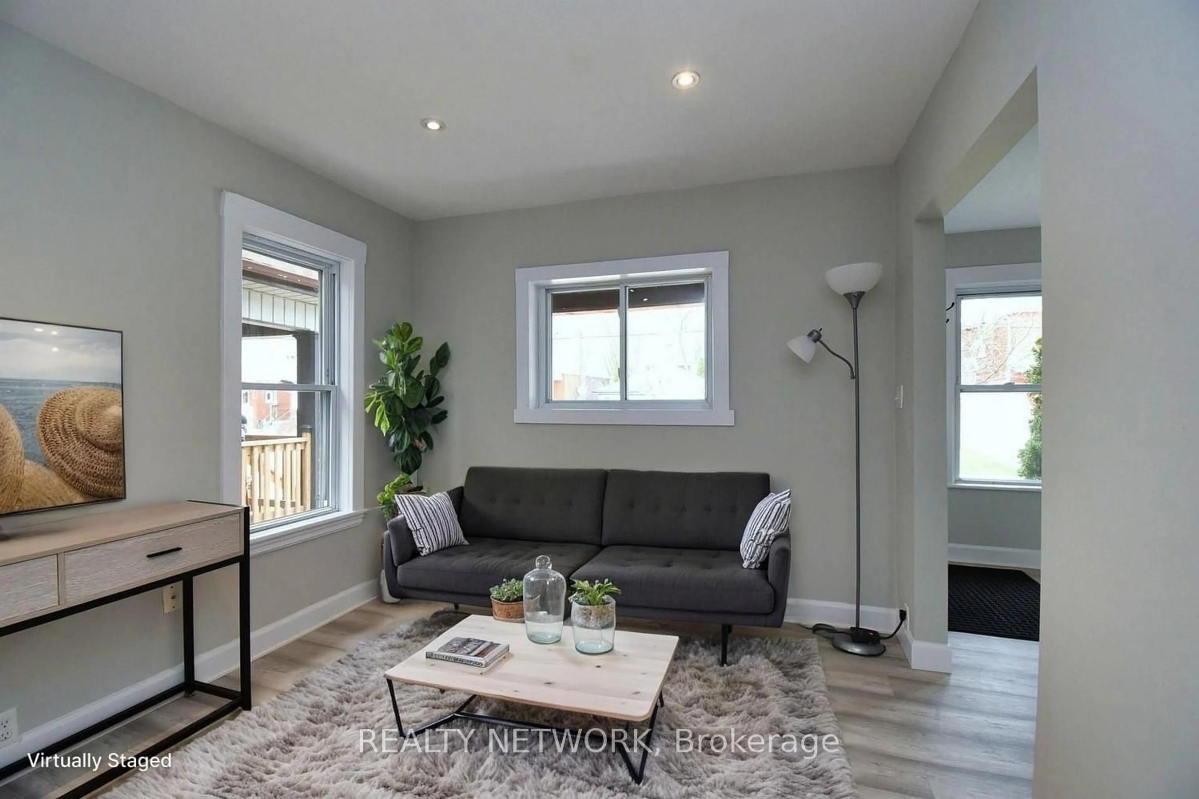 Living room with furniture, wood/laminate floor for 82 Alpine Ave, Hamilton Ontario L9A 1A6