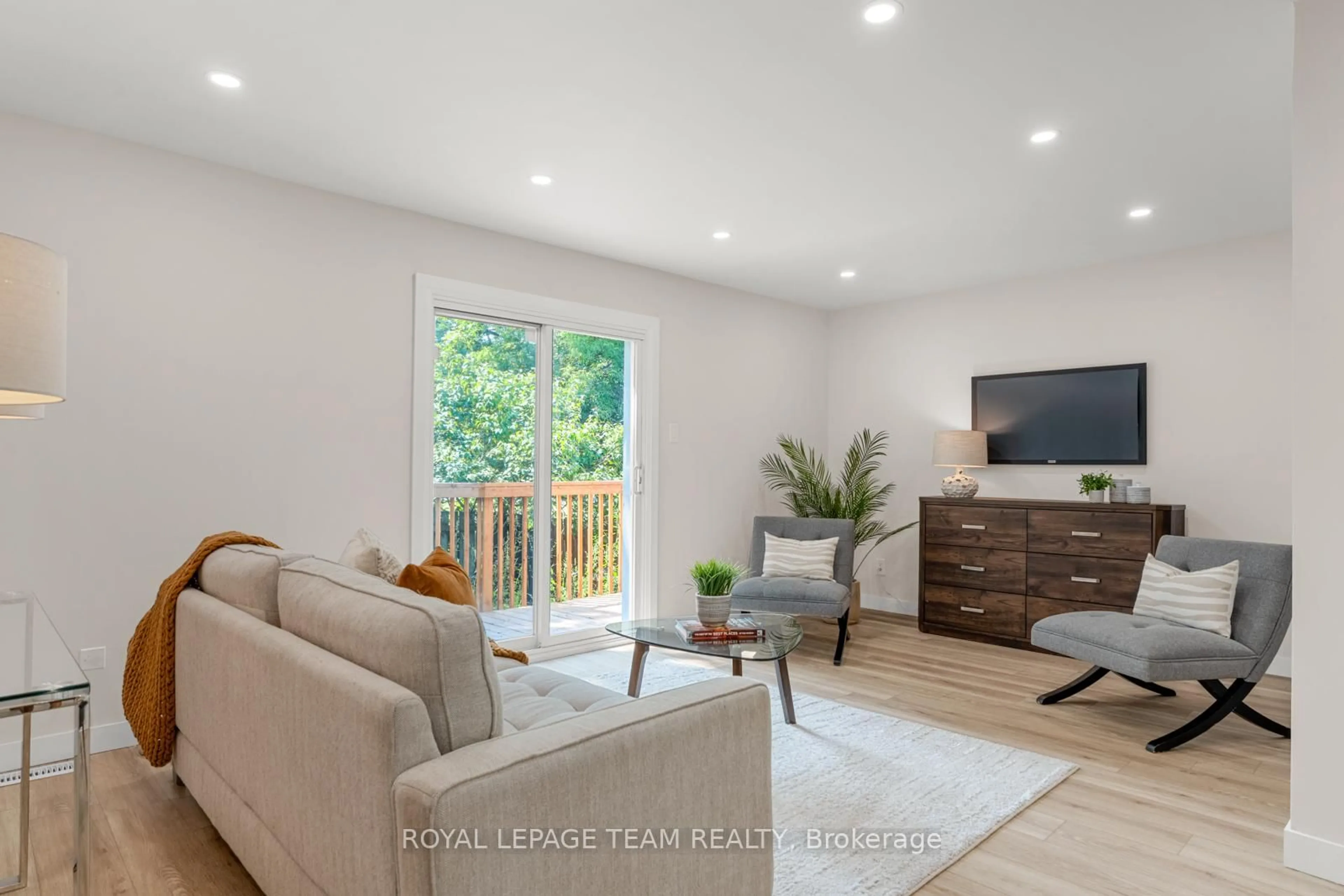Living room with furniture, wood/laminate floor for 54 Greenboro Cres, Ottawa Ontario K1T 1W5