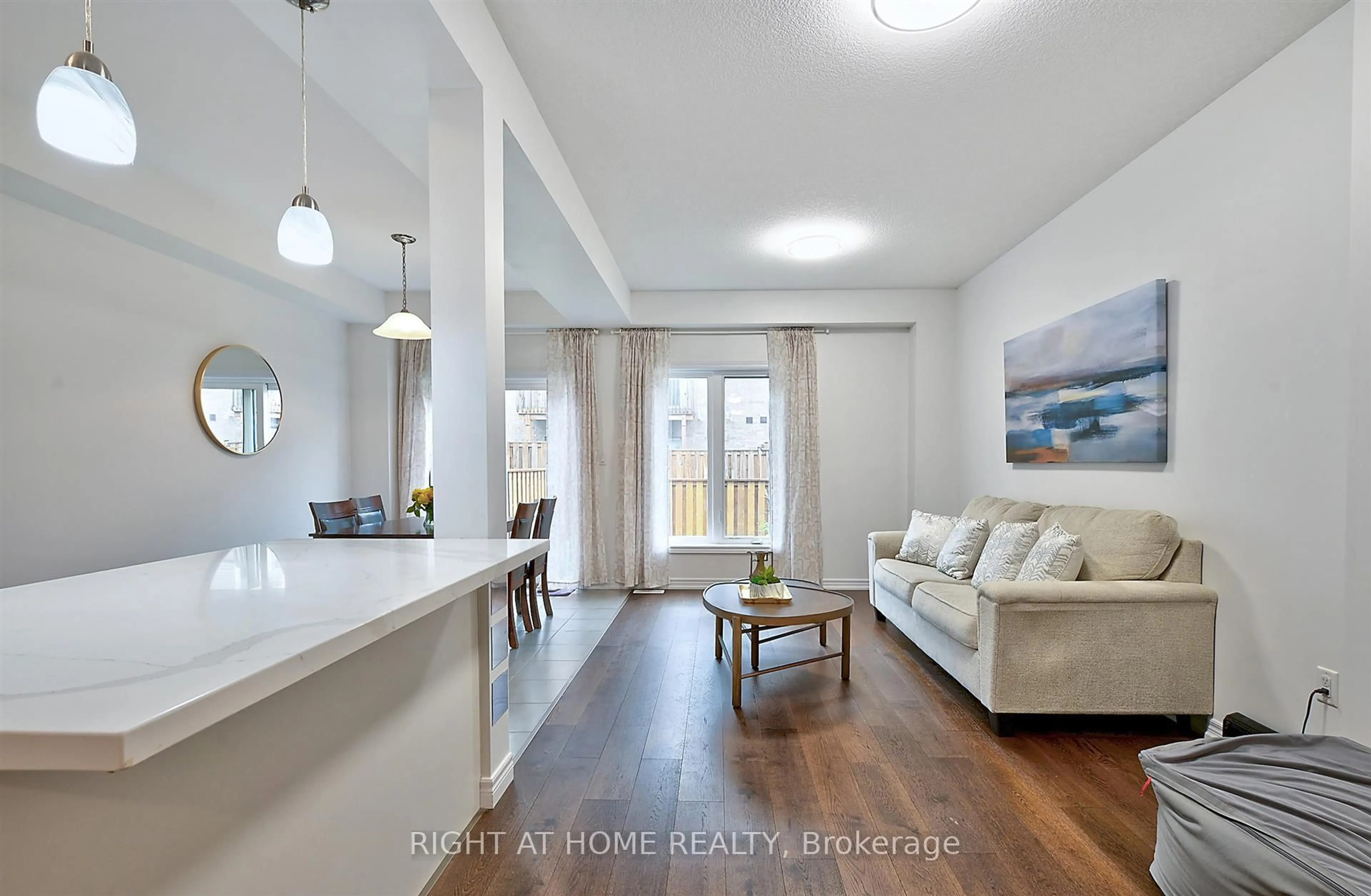 Living room with furniture, wood/laminate floor for 15 Garlent Ave, Hamilton Ontario L9K 0J9
