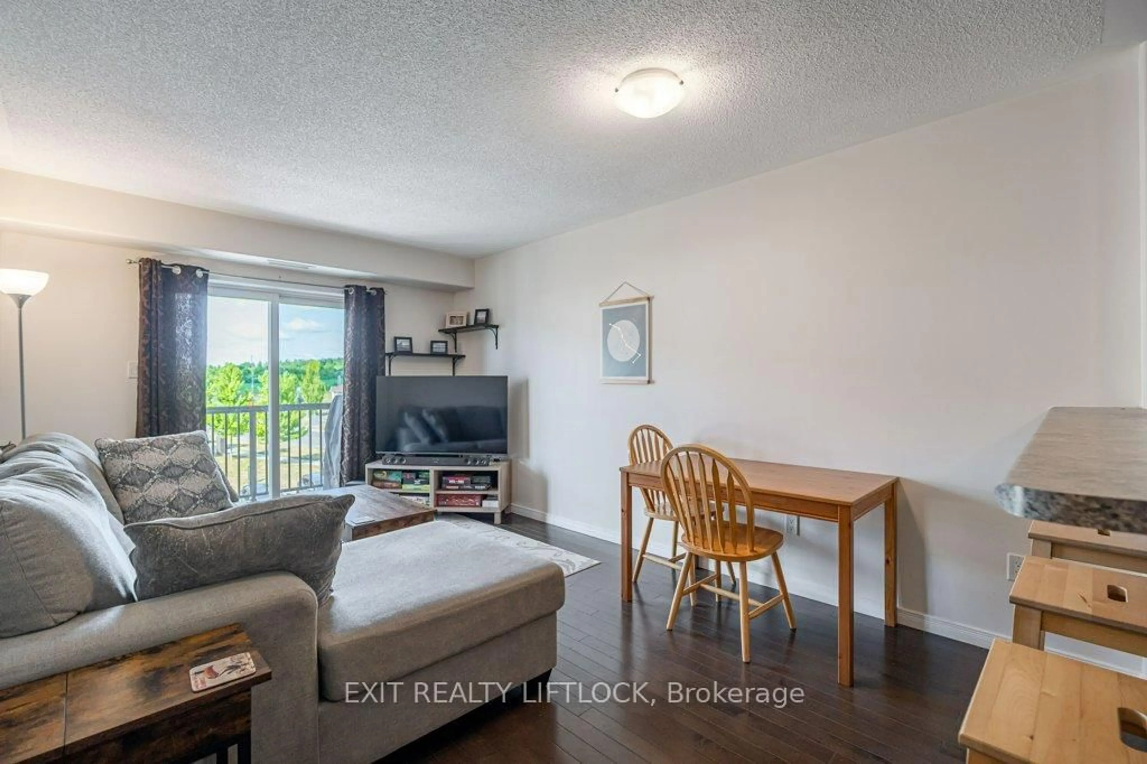 Living room with furniture, wood/laminate floor for 312 Spillsbury Dr #303, Peterborough West Ontario K9K 0B6