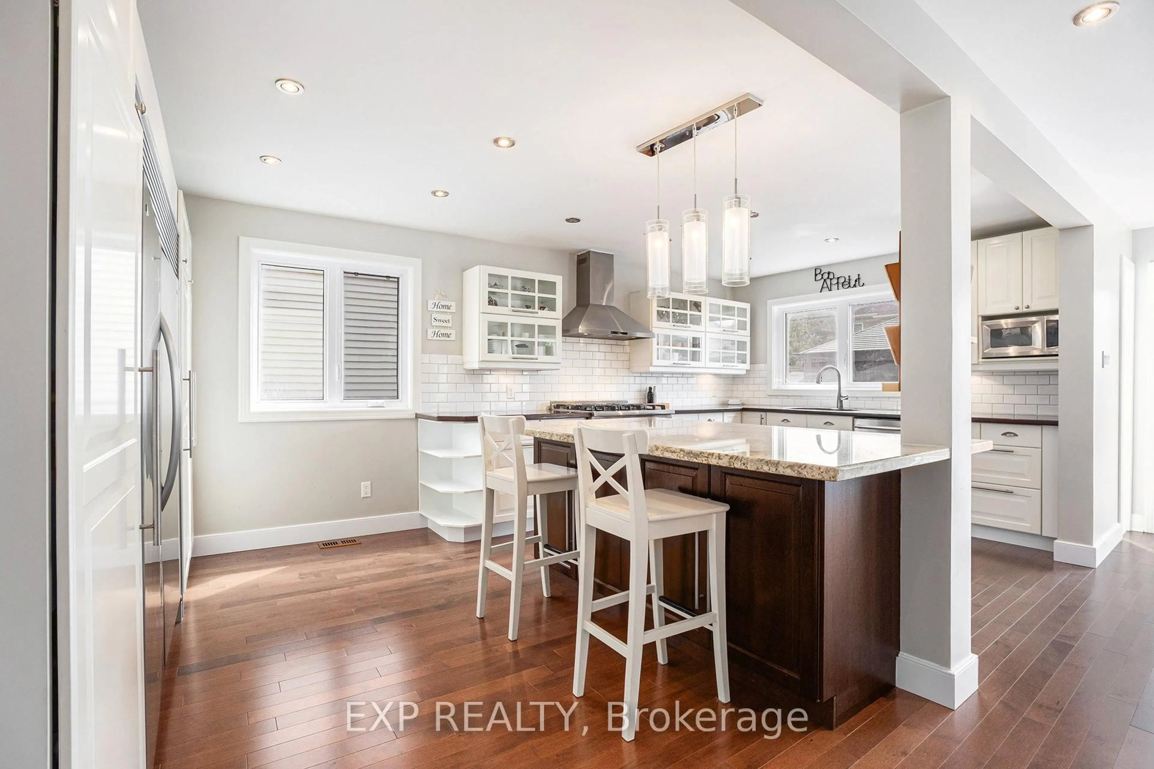 Open concept kitchen, wood/laminate floor for 2010 Rolling Brook Dr, Ottawa Ontario K1W 1C7
