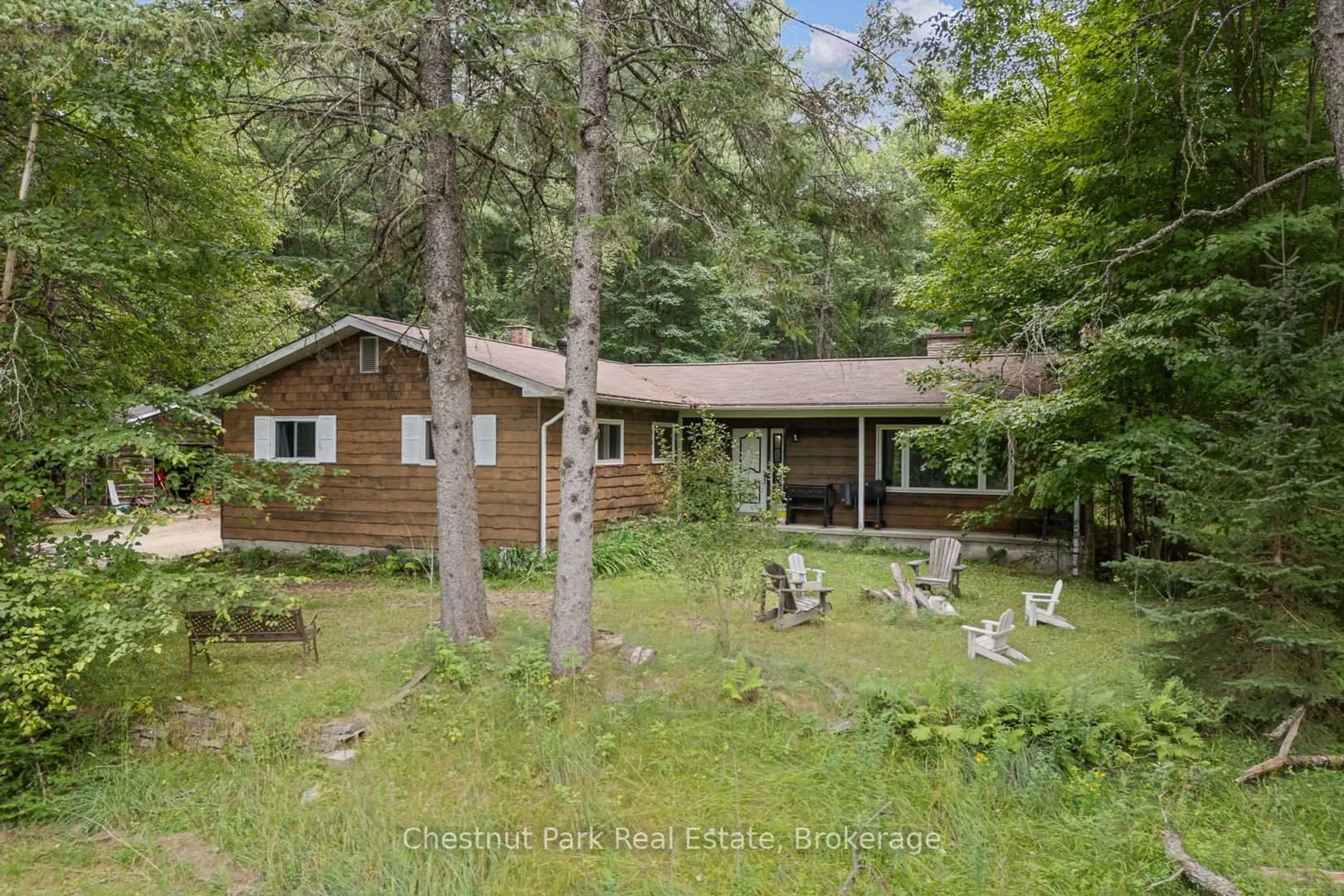 A pic from outside/outdoor area/front of a property/back of a property/a pic from drone, forest/trees view for 59 Crockford Lane, Huntsville Ontario P0B 1L0
