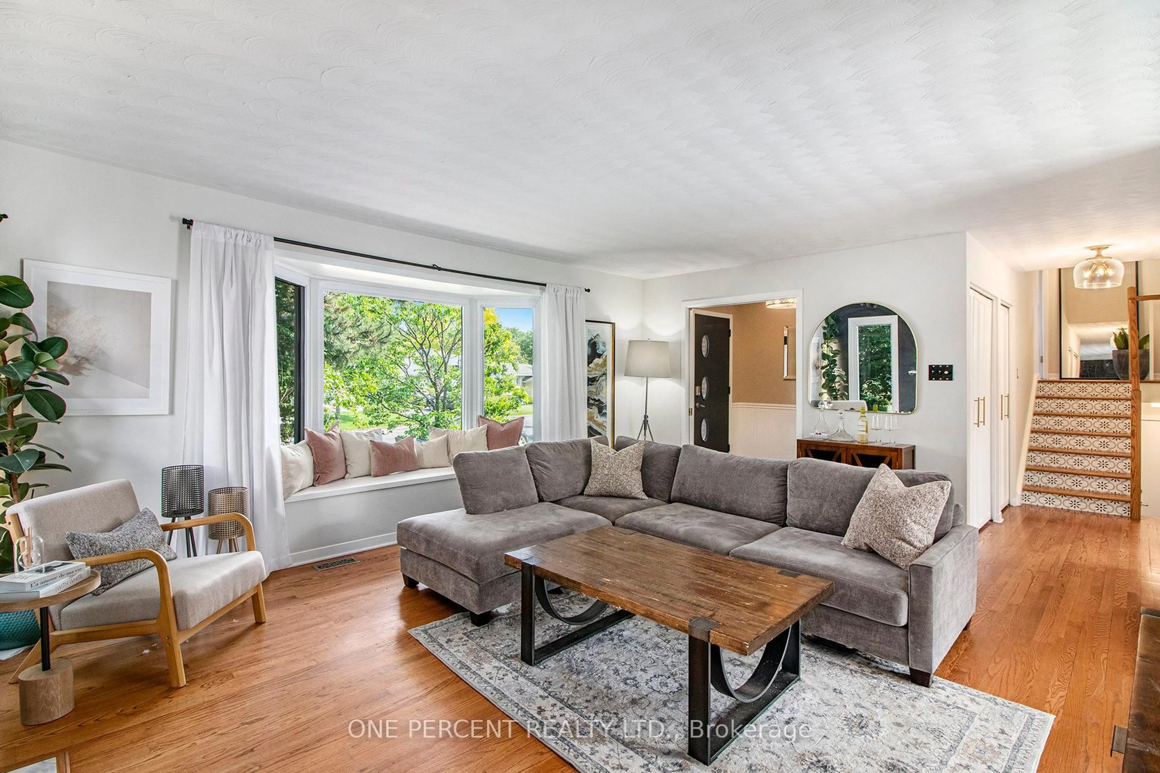 Living room with furniture, wood/laminate floor for 1042 Harkness Ave, Ottawa Ontario K1V 6P2