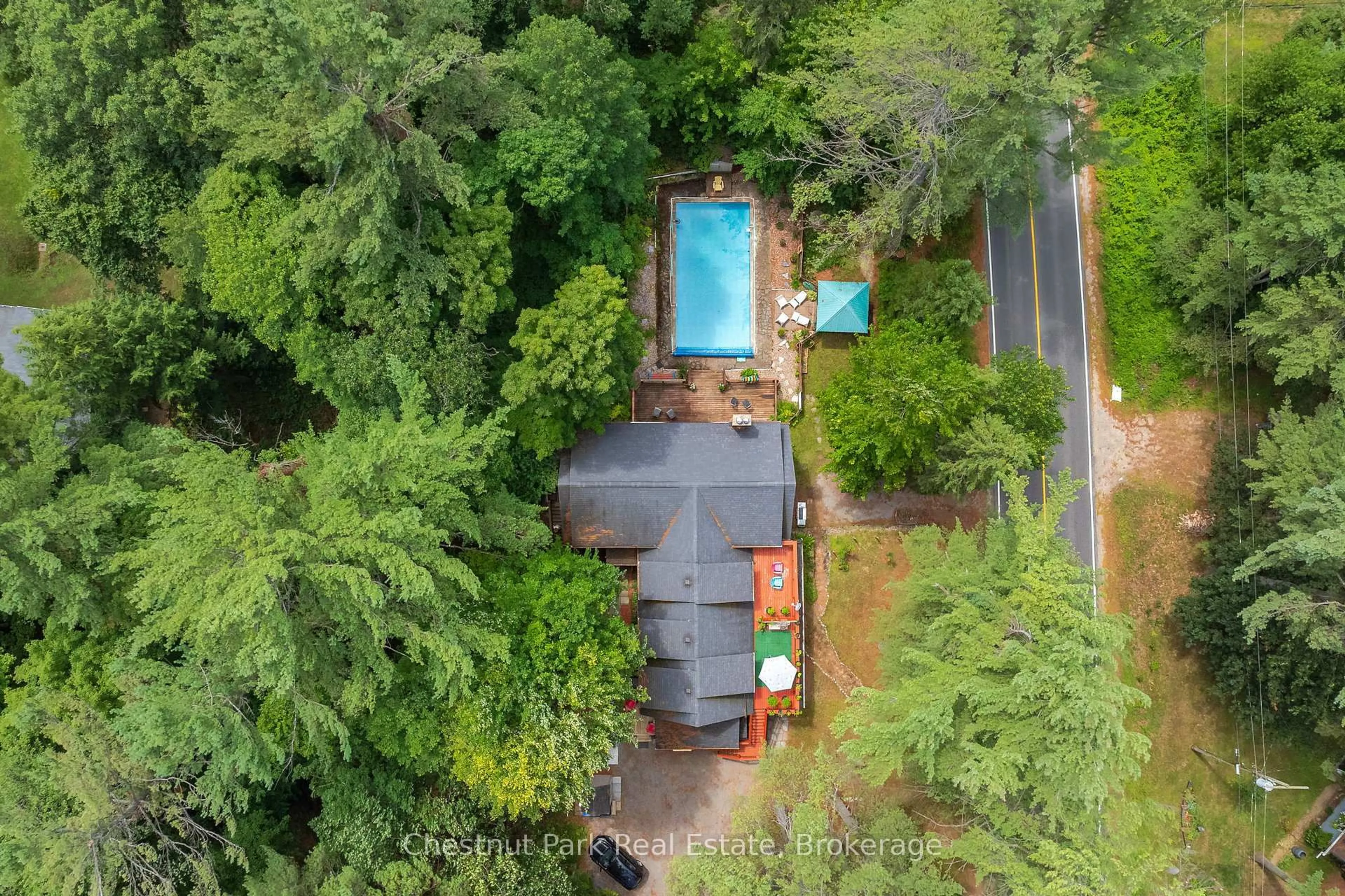 A pic from outside/outdoor area/front of a property/back of a property/a pic from drone, forest/trees view for 869 Muskoka Road 10, Huntsville Ontario P0B 1L0